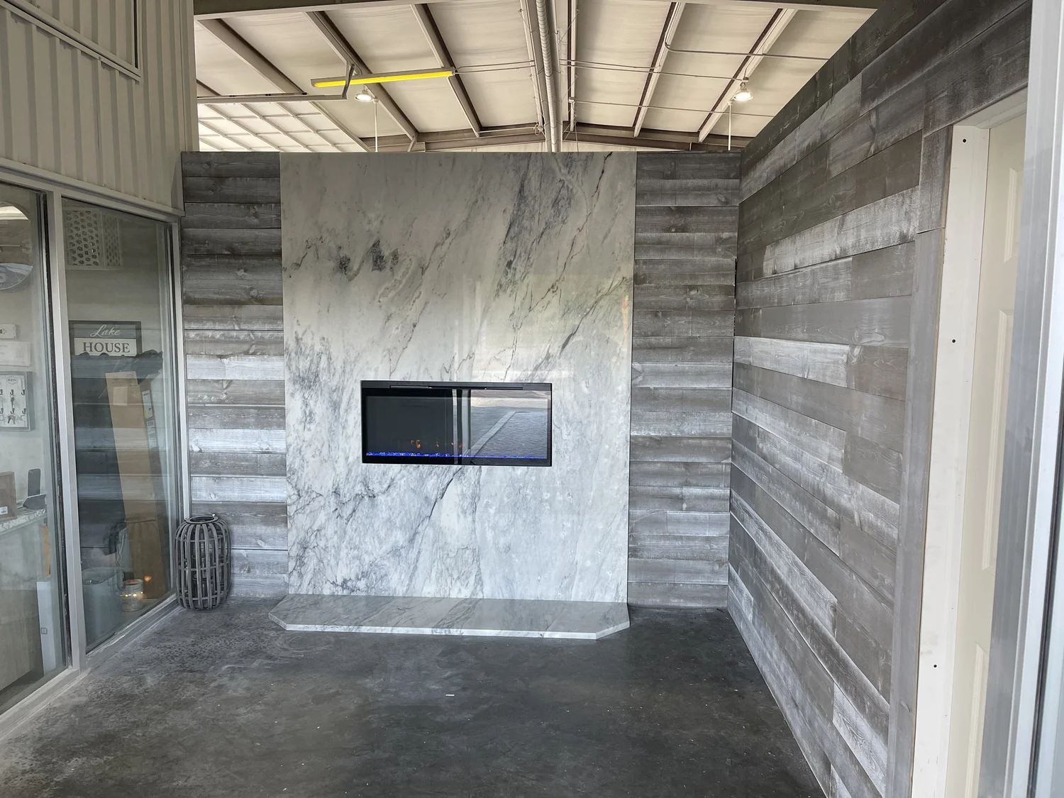 Granite counter run and fireplace hearth surround in an open living space, fabricated by Stone Restore Solutions