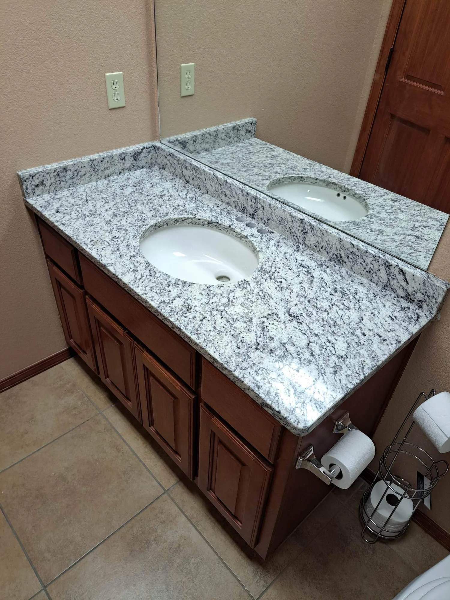 Granite vanity top with an oval sink in a guest bathroom