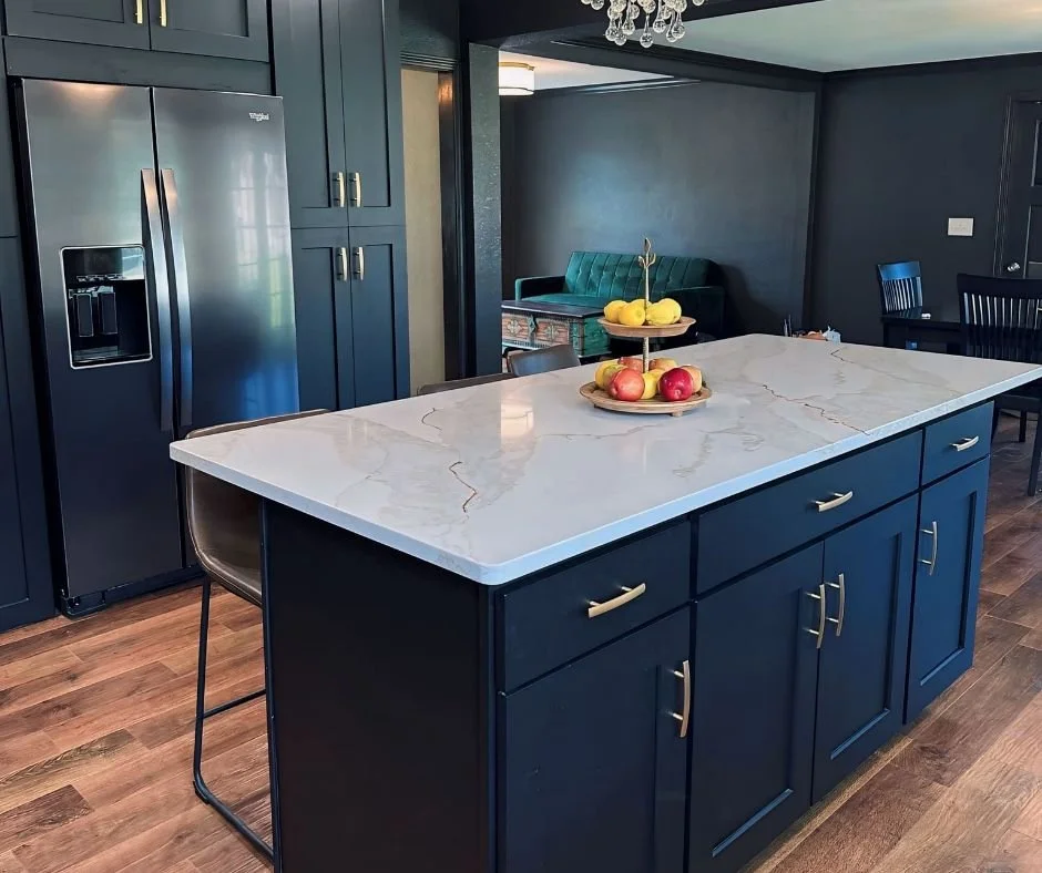 Navy cabinets and quartz countertops in a modern farmhouse kitchen