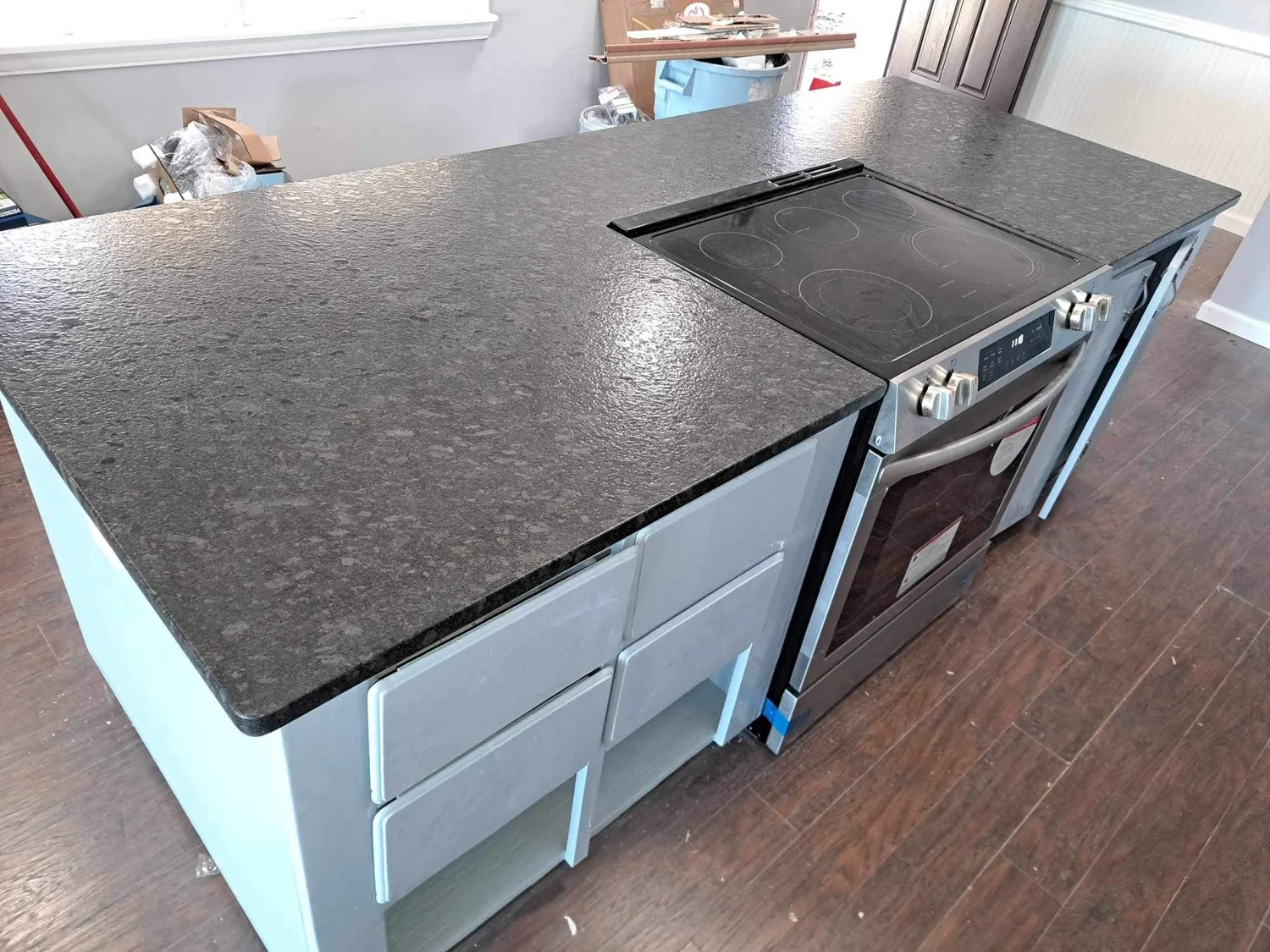 Leathered-finish granite countertops with a tile backsplash