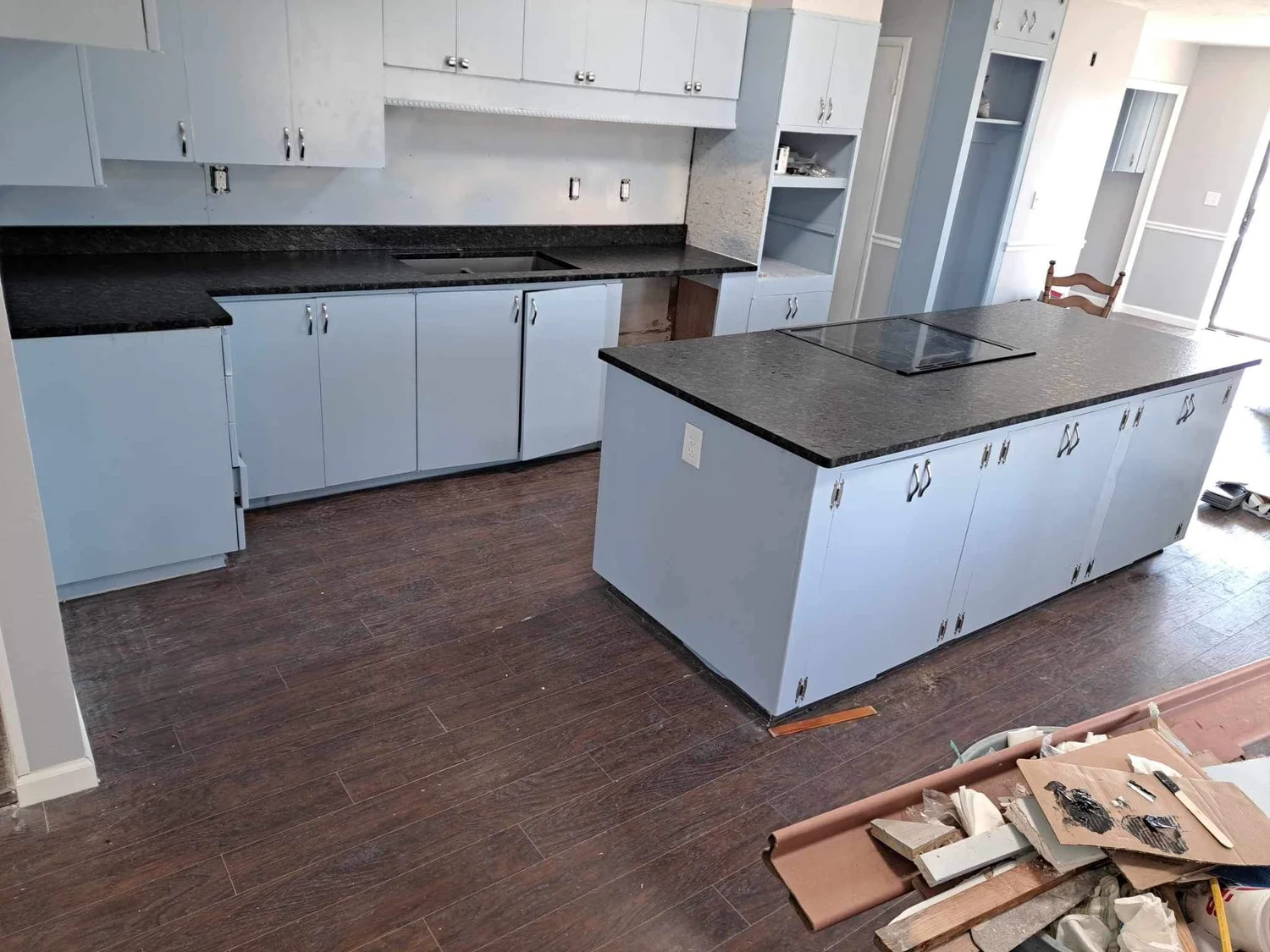 Dark granite countertops paired with white painted cabinetry