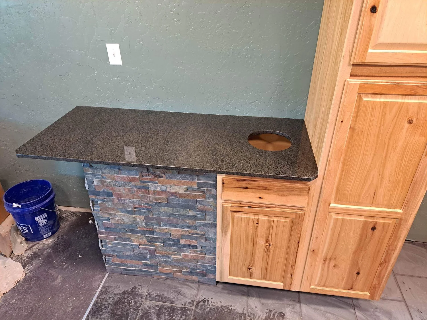 Dark stone bar top over a stacked stone base