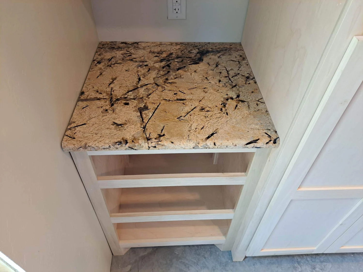 Granite shelf and nook surfaces built into a cabinet niche