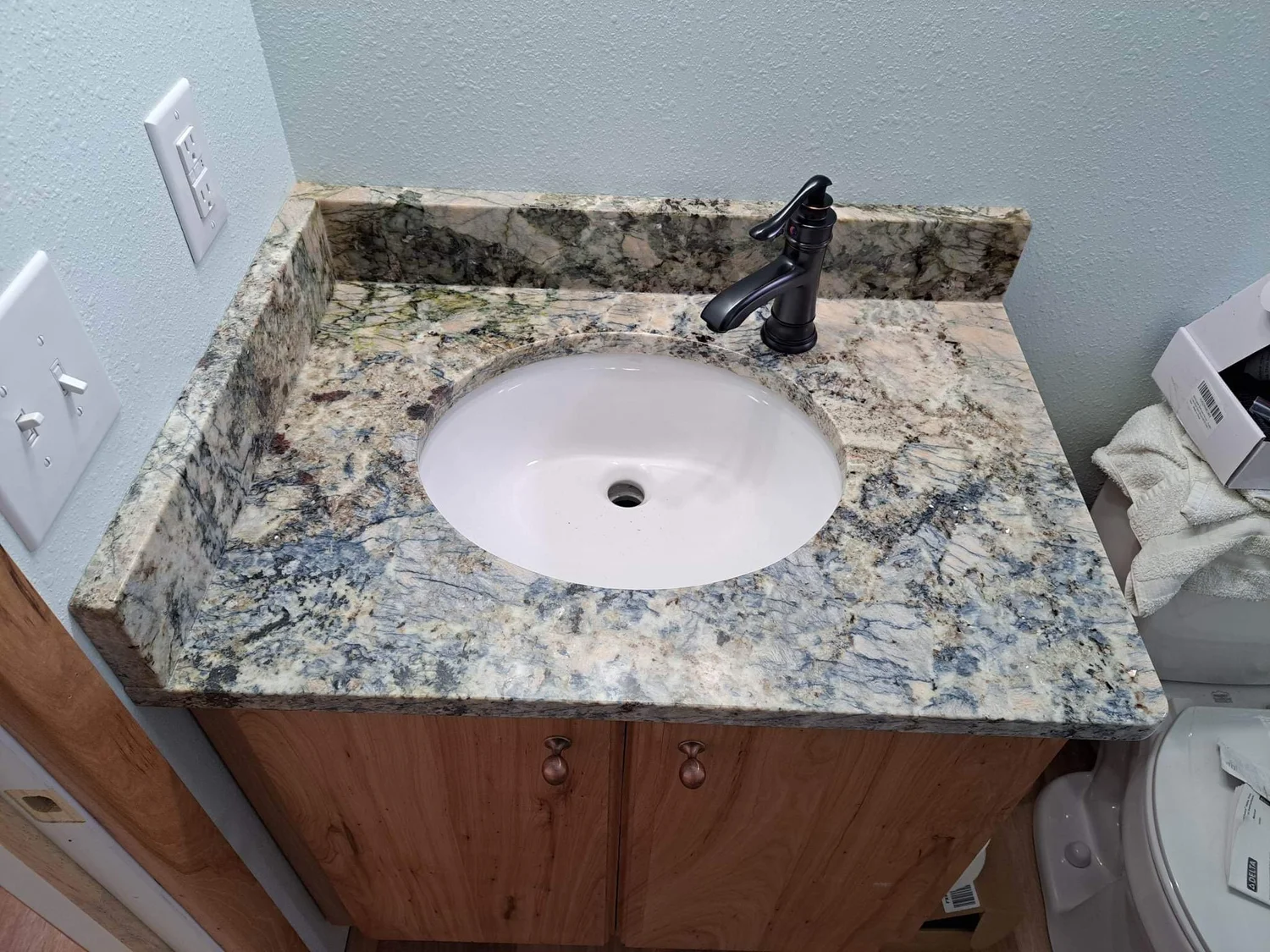 Black granite ledge and sill detail at a pass-through opening