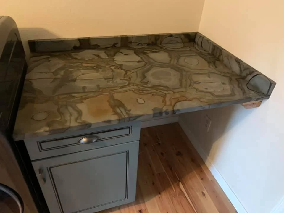 Stone top on a built-in desk and cabinet run