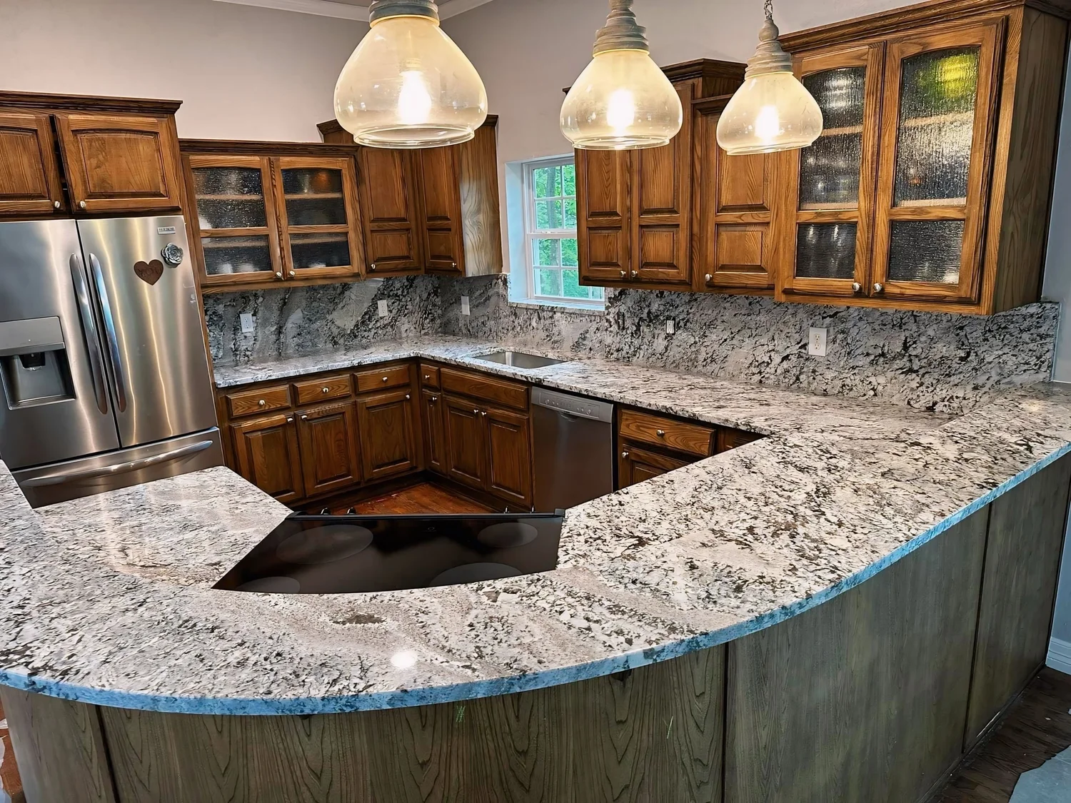 Curved teal stone bar top staged during fabrication