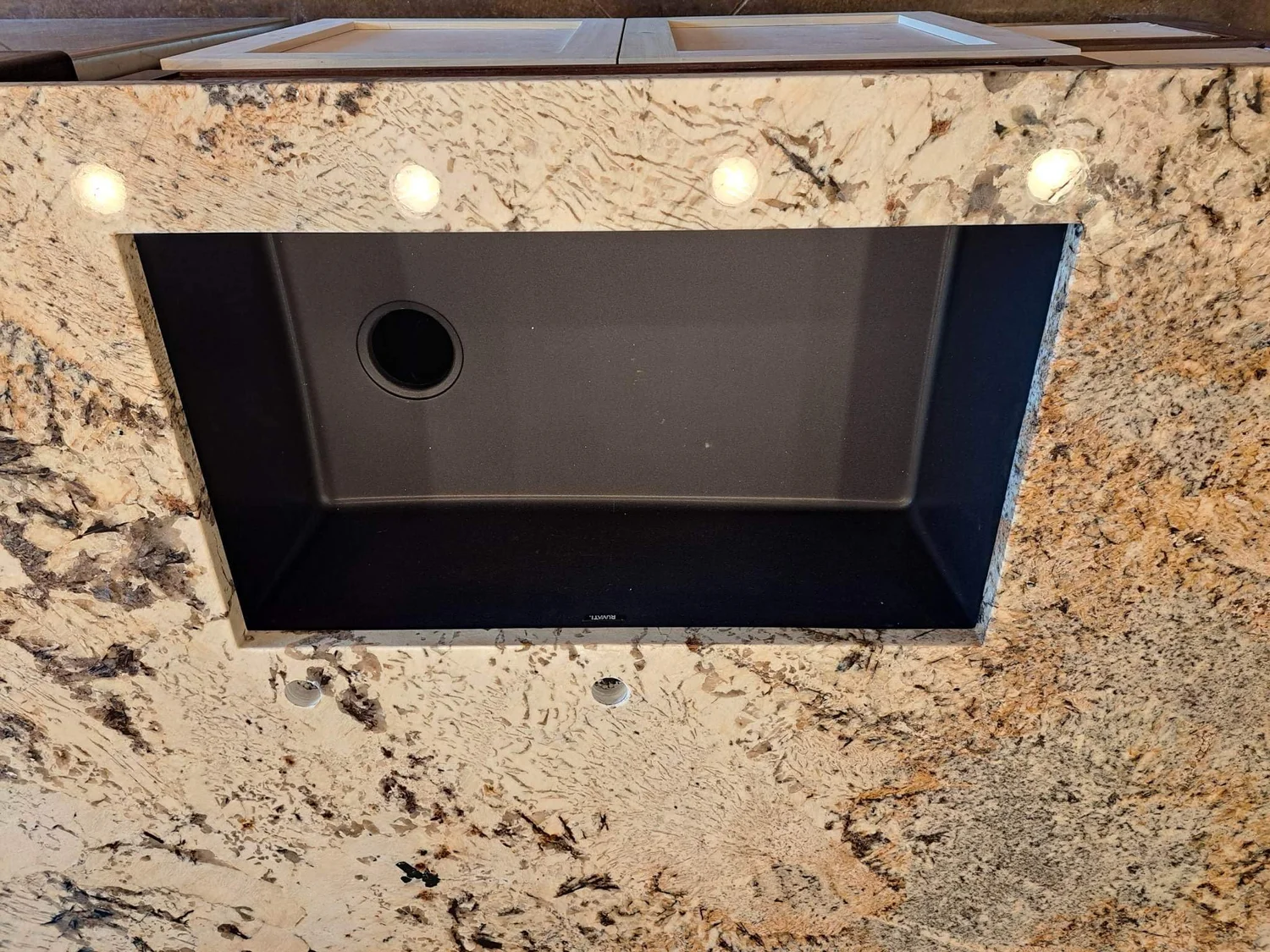 Precision cooktop cutout in a black granite countertop
