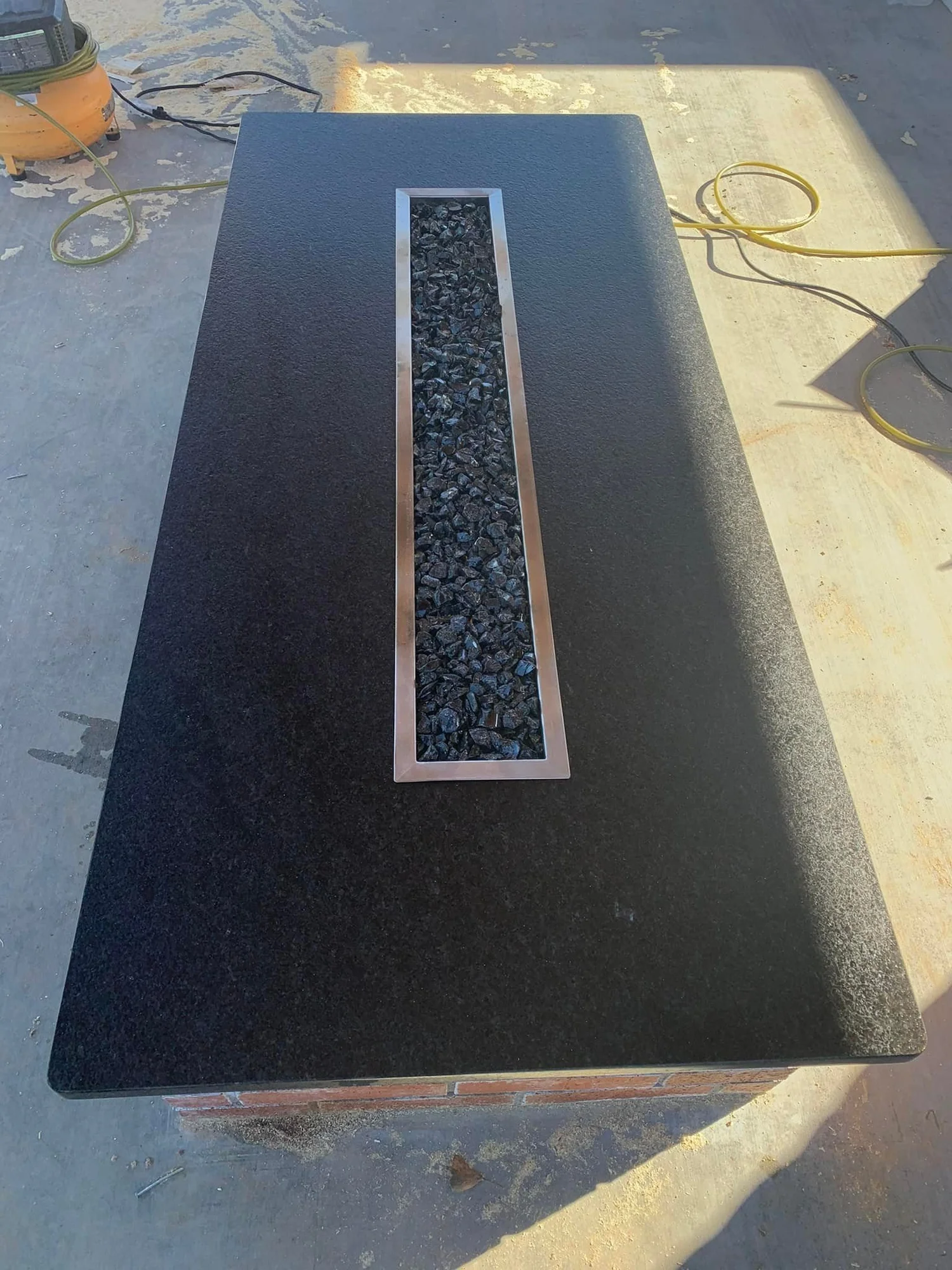 Black stone slab with a routed channel detail