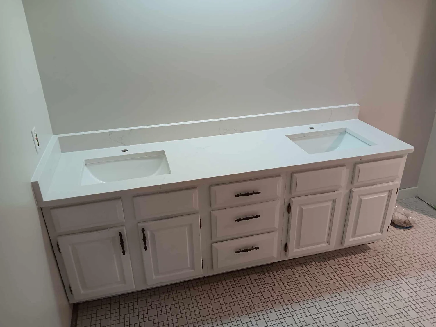 White double vanity with a stone top and two undermount sinks