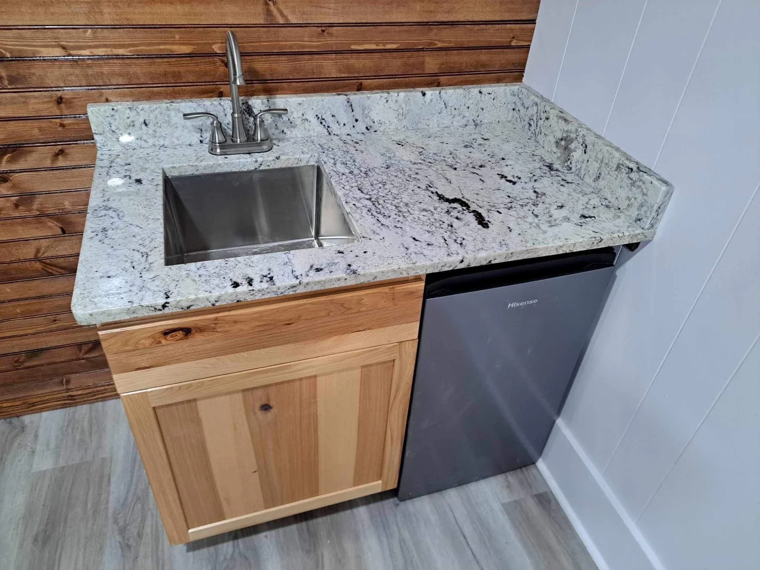 Granite bar-height countertop with an integrated stainless prep sink