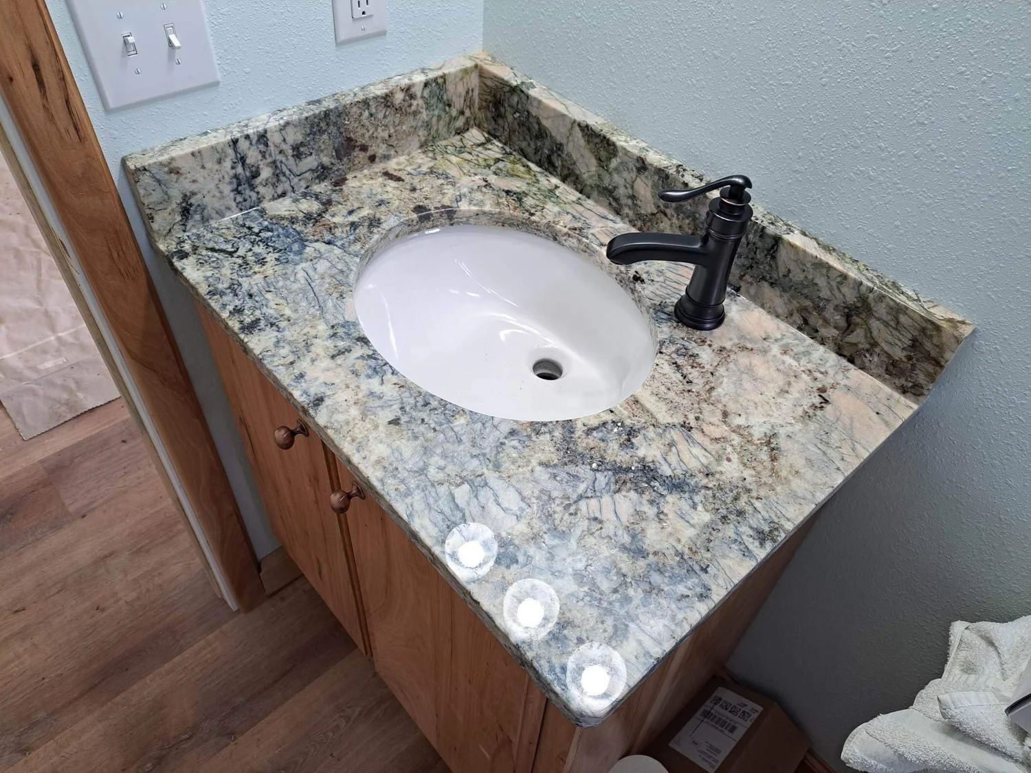 Gold and copper toned granite bar countertop with an undermount sink