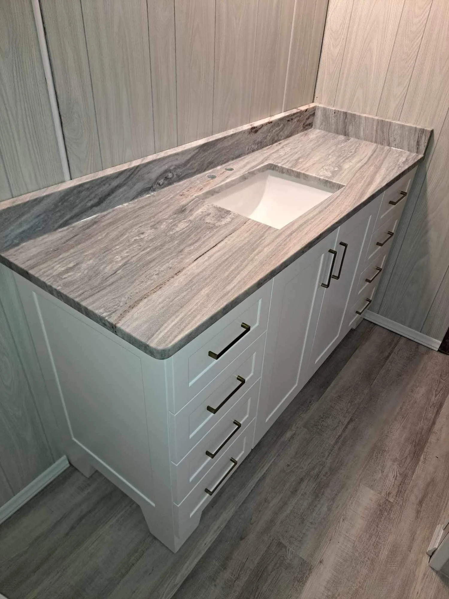 Stone double vanity top on a white painted bathroom cabinet