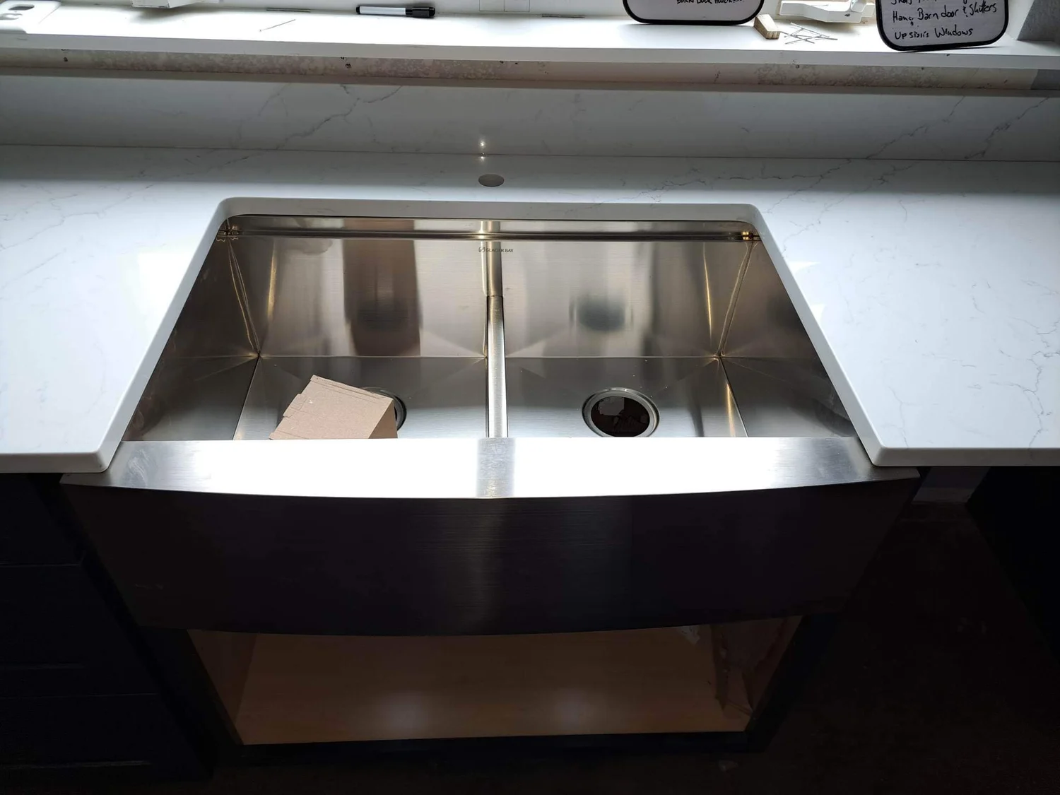 Stainless steel workstation sink prepared for a stone countertop