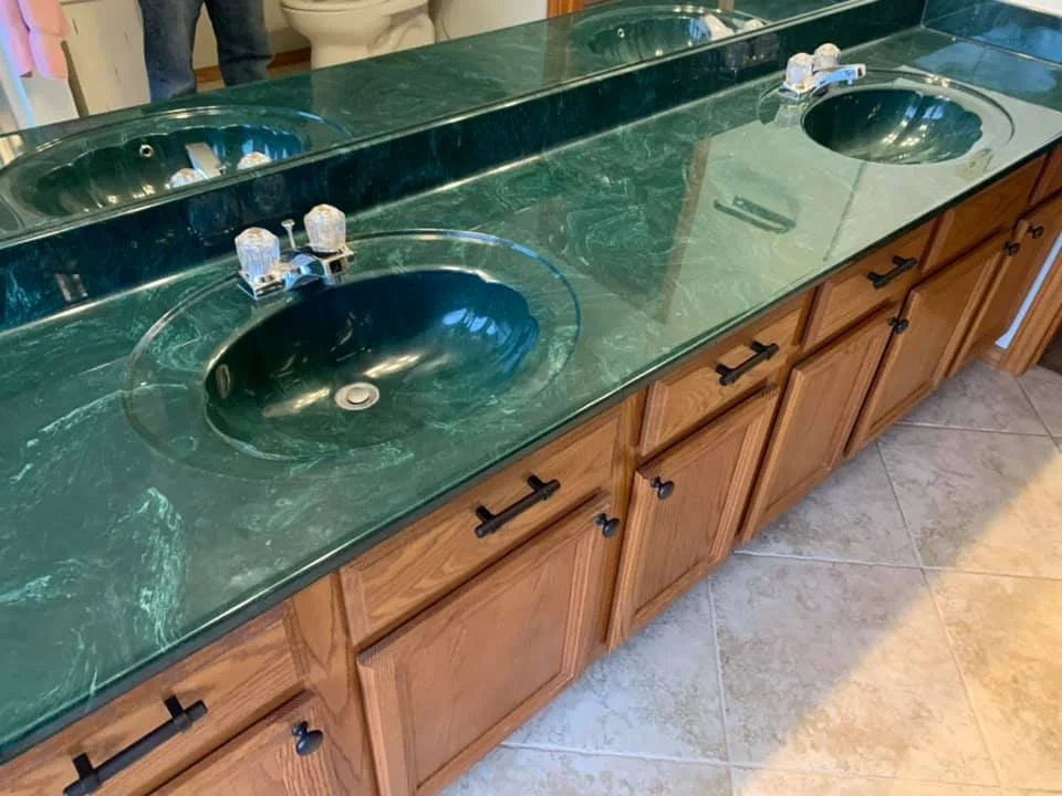 Deep green stone double vanity top with two oval sinks