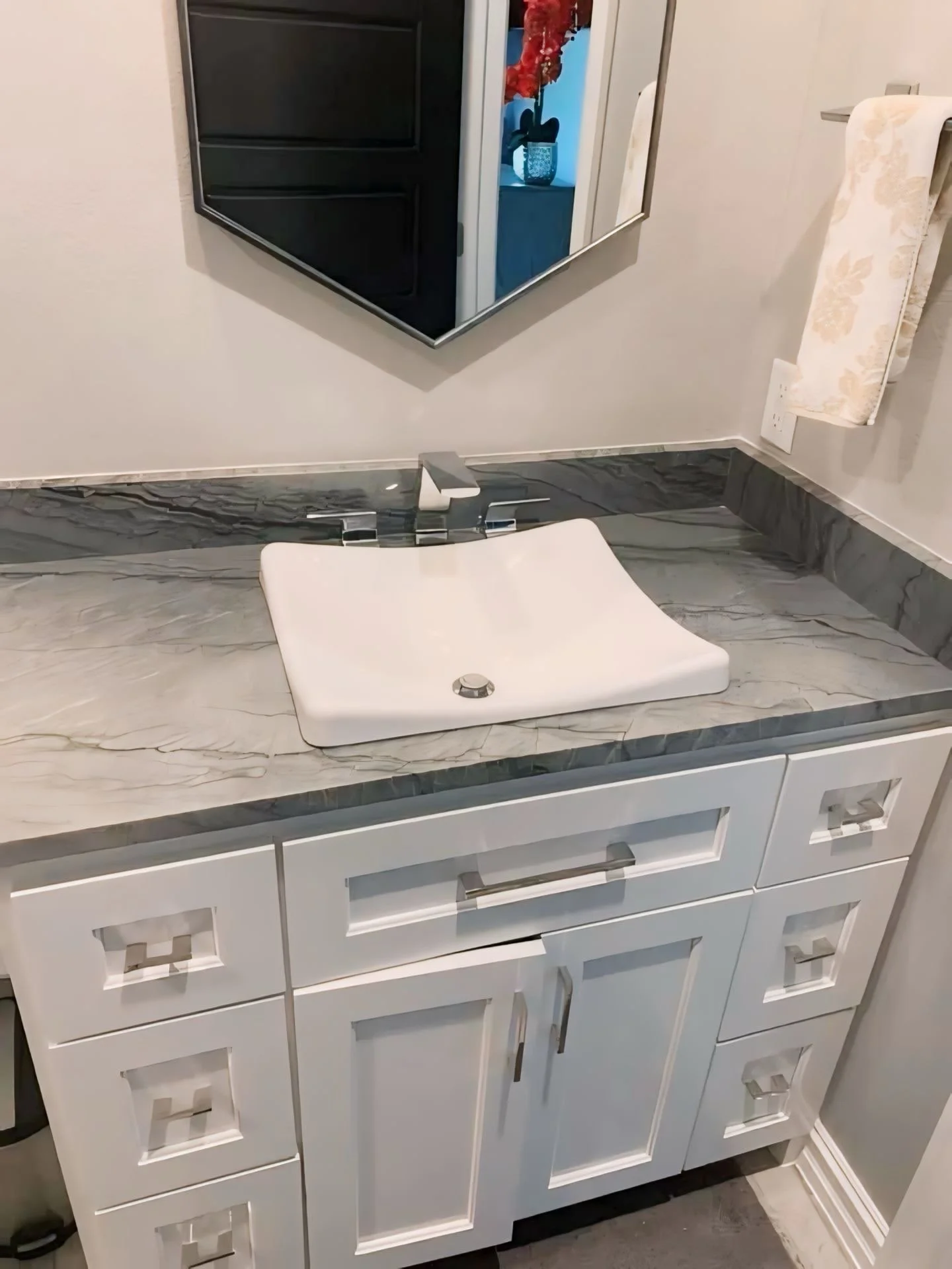 Veined stone vanity top installed on a wood bathroom cabinet