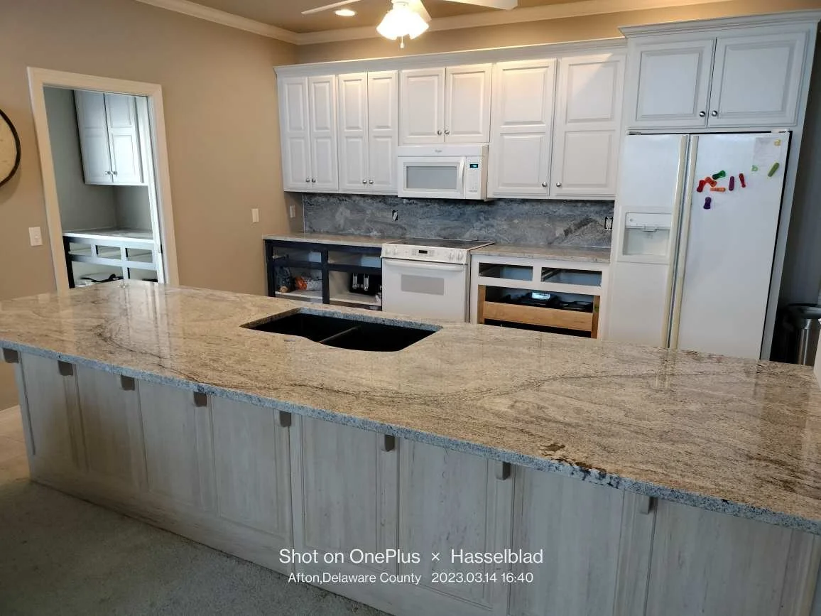 Granite countertops and breakfast bar in a light-filled kitchen