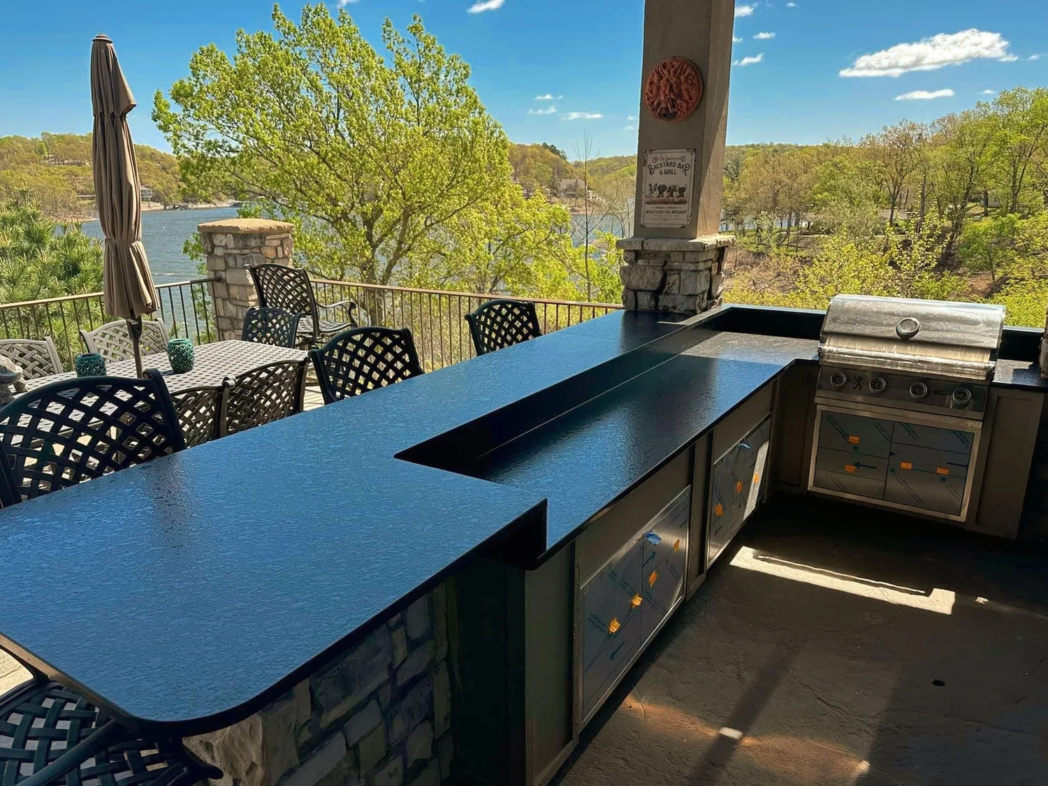 Black stone outdoor counter and bar overlooking open water