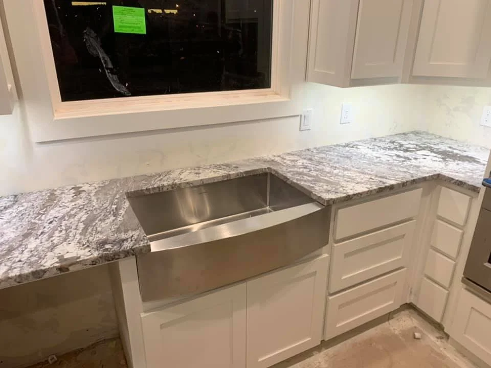 White quartz kitchen countertop with an undermount stainless steel sink