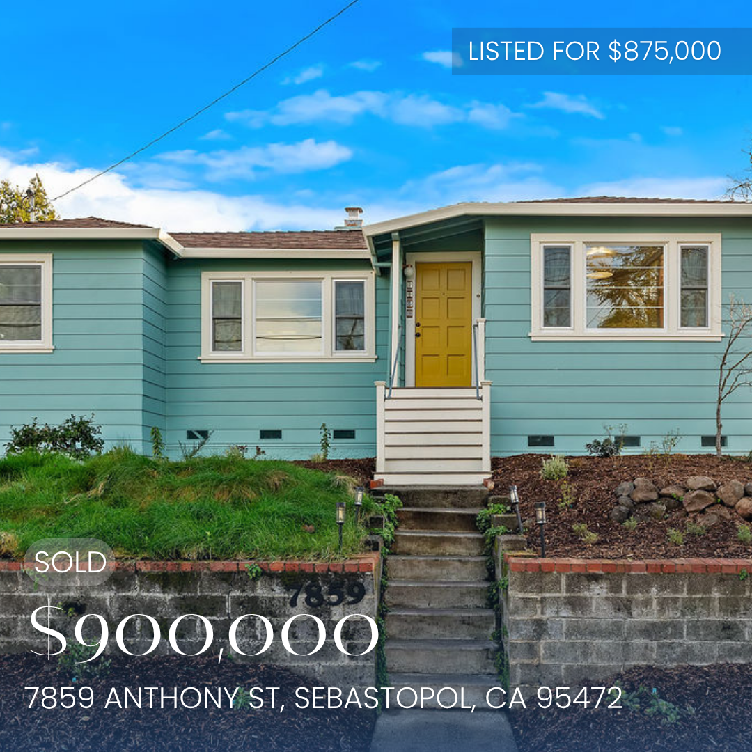 Front view of a light blue house with a yellow front door, front steps, and 