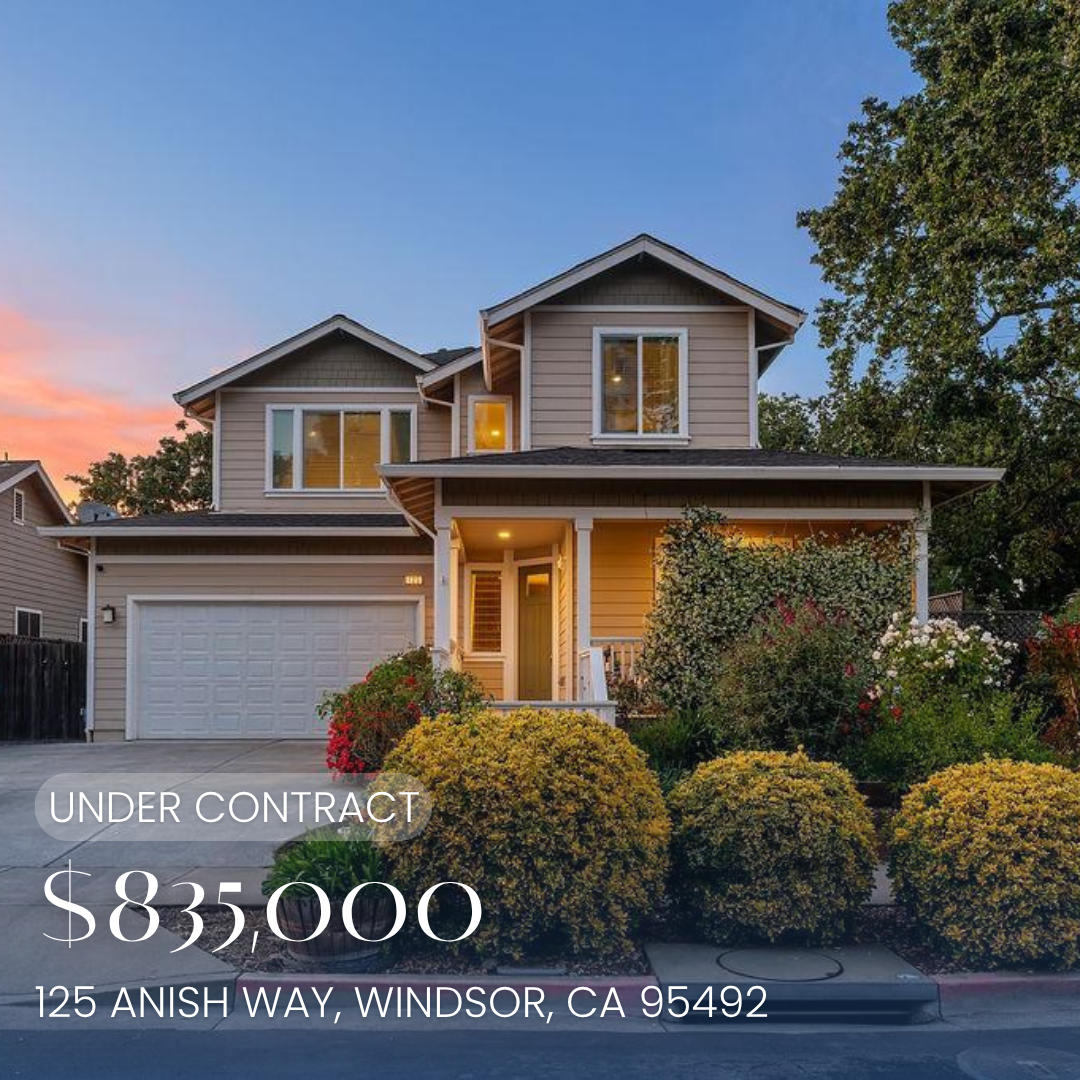 Front view of a two-story house with a beige exterior, white trim, a garage, and a front porch surrounded by bushes and plants. Listed for sale at $895,000, located at 125 Anish Way, Windsor, CA 95492.