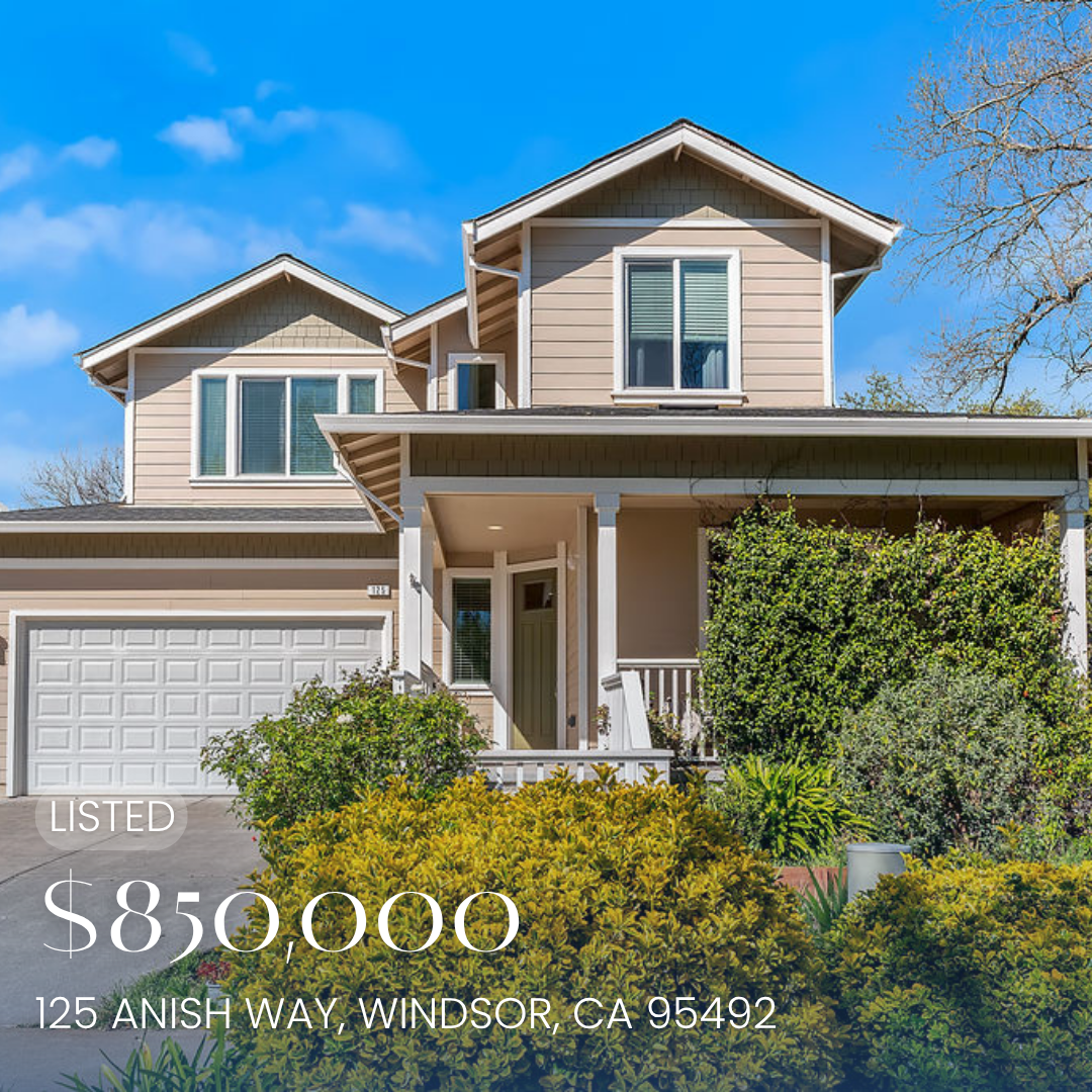 Front view of a two-story house with a beige exterior, white trim, a garage, and a front porch surrounded by bushes and plants. Listed for sale at $895,000, located at 125 Anish Way, Windsor, CA 95492.