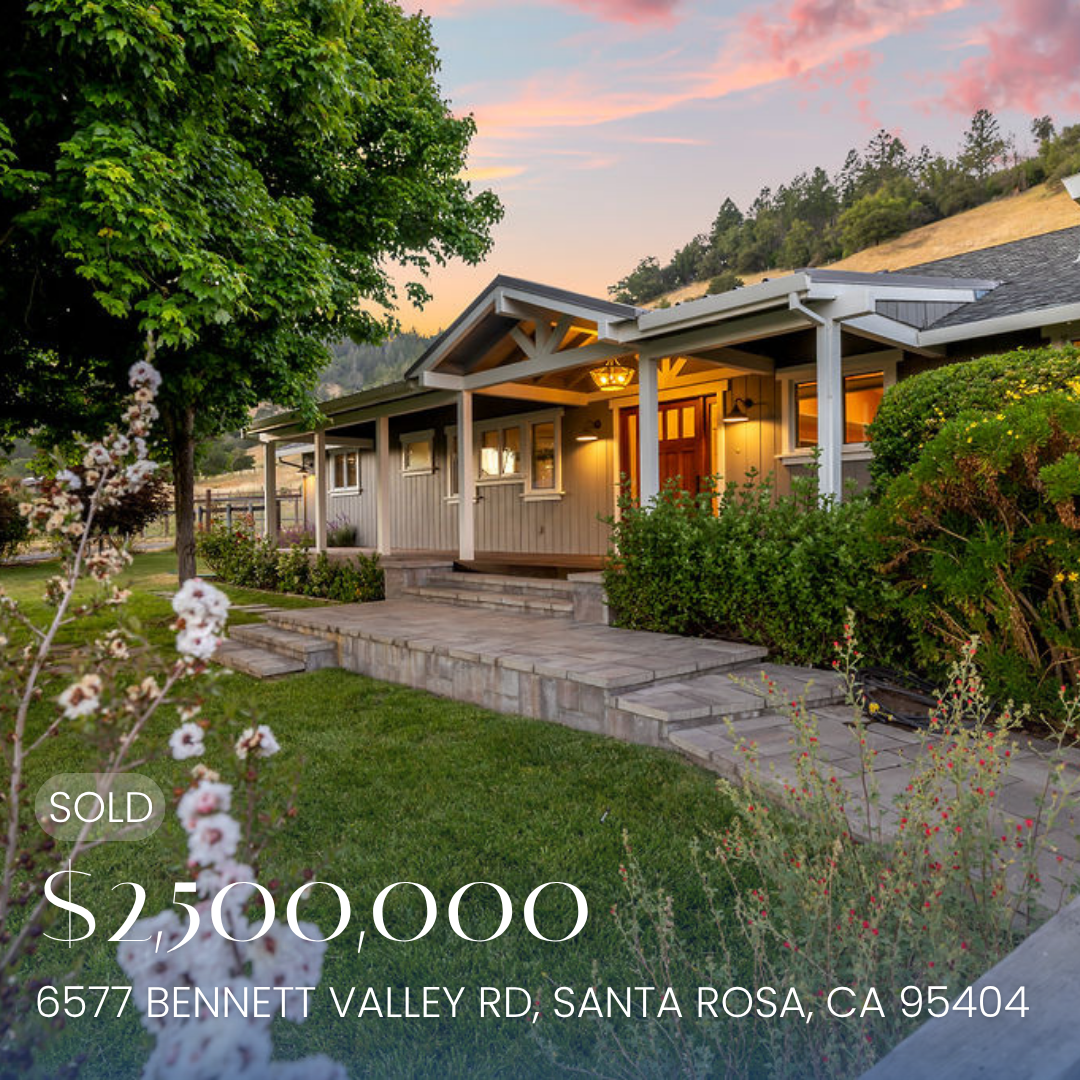 A large, green, two-story house with solar panels on the roof, illuminated by exterior lights during sunset, with a backyard that includes patio furniture, string lights, a hot tub, and a landscaped yard. The house is listed for sale at $2,000,000, located at 5644 Eastlake Drive, Santa Rosa, California.