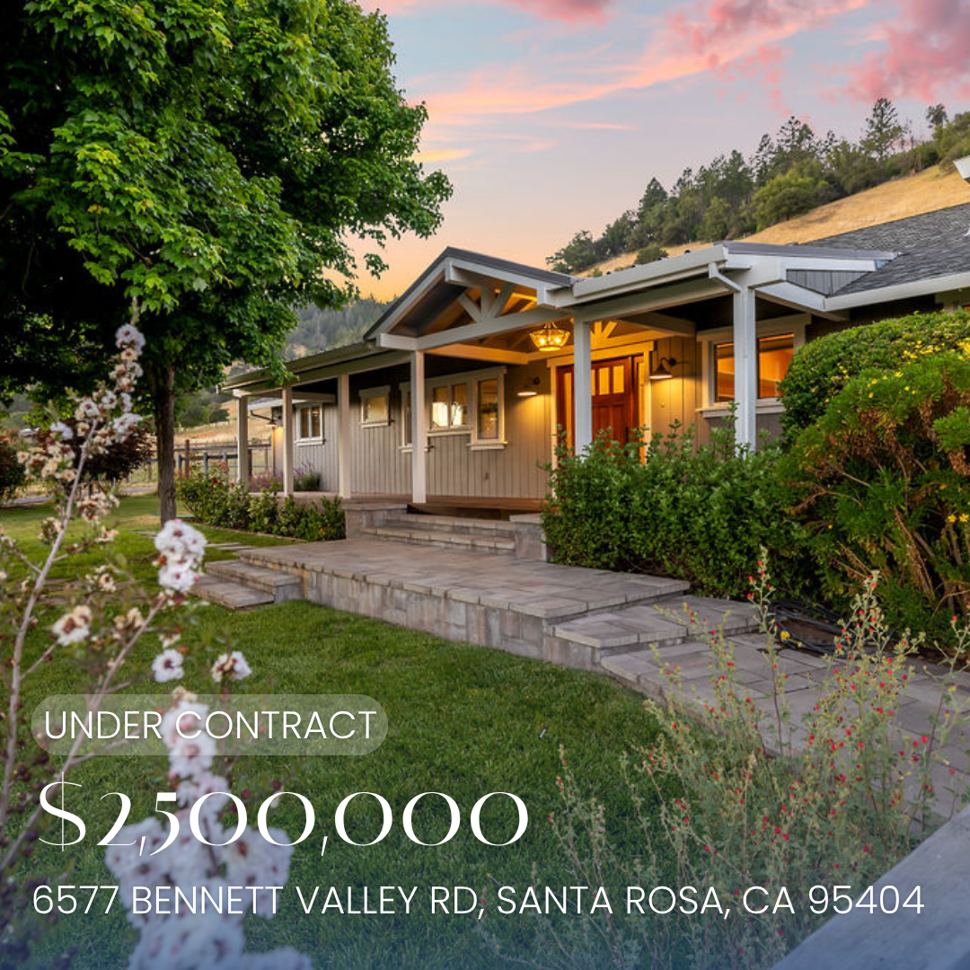 A large, green, two-story house with solar panels on the roof, illuminated by exterior lights during sunset, with a backyard that includes patio furniture, string lights, a hot tub, and a landscaped yard. The house is listed for sale at $2,000,000, located at 5644 Eastlake Drive, Santa Rosa, California.