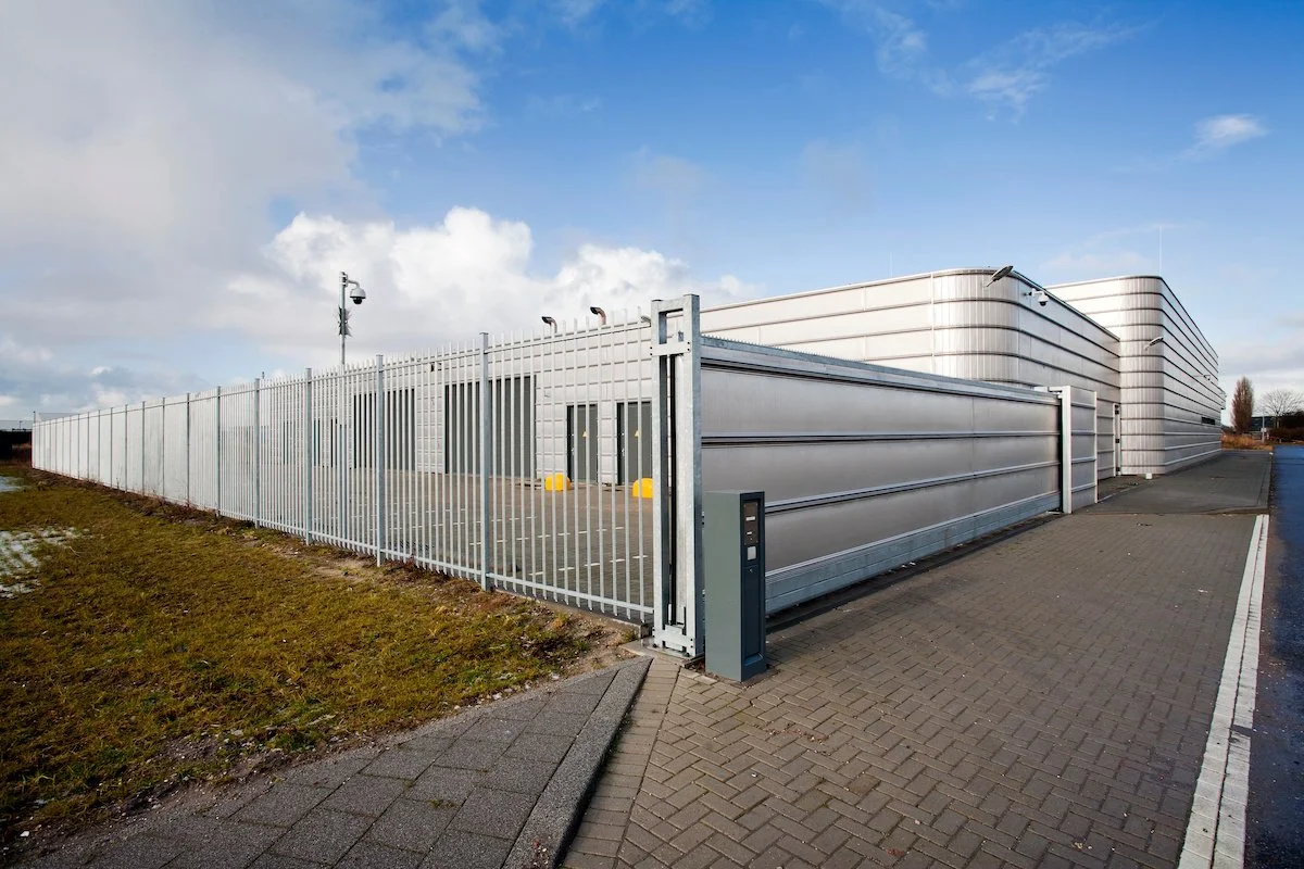 Gated entrance and security fence at a commercial facility