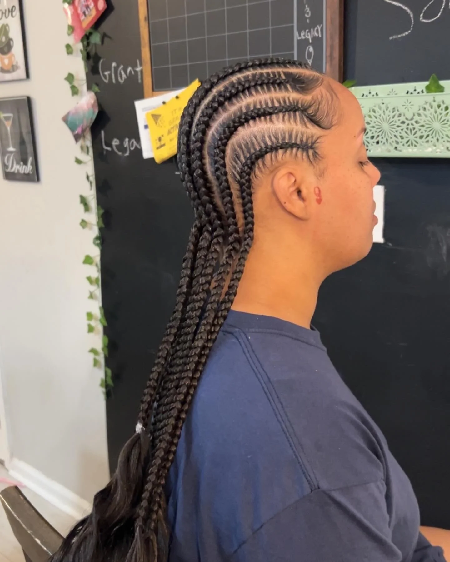 Side view of a woman with long, fresh box braids hairstyle.