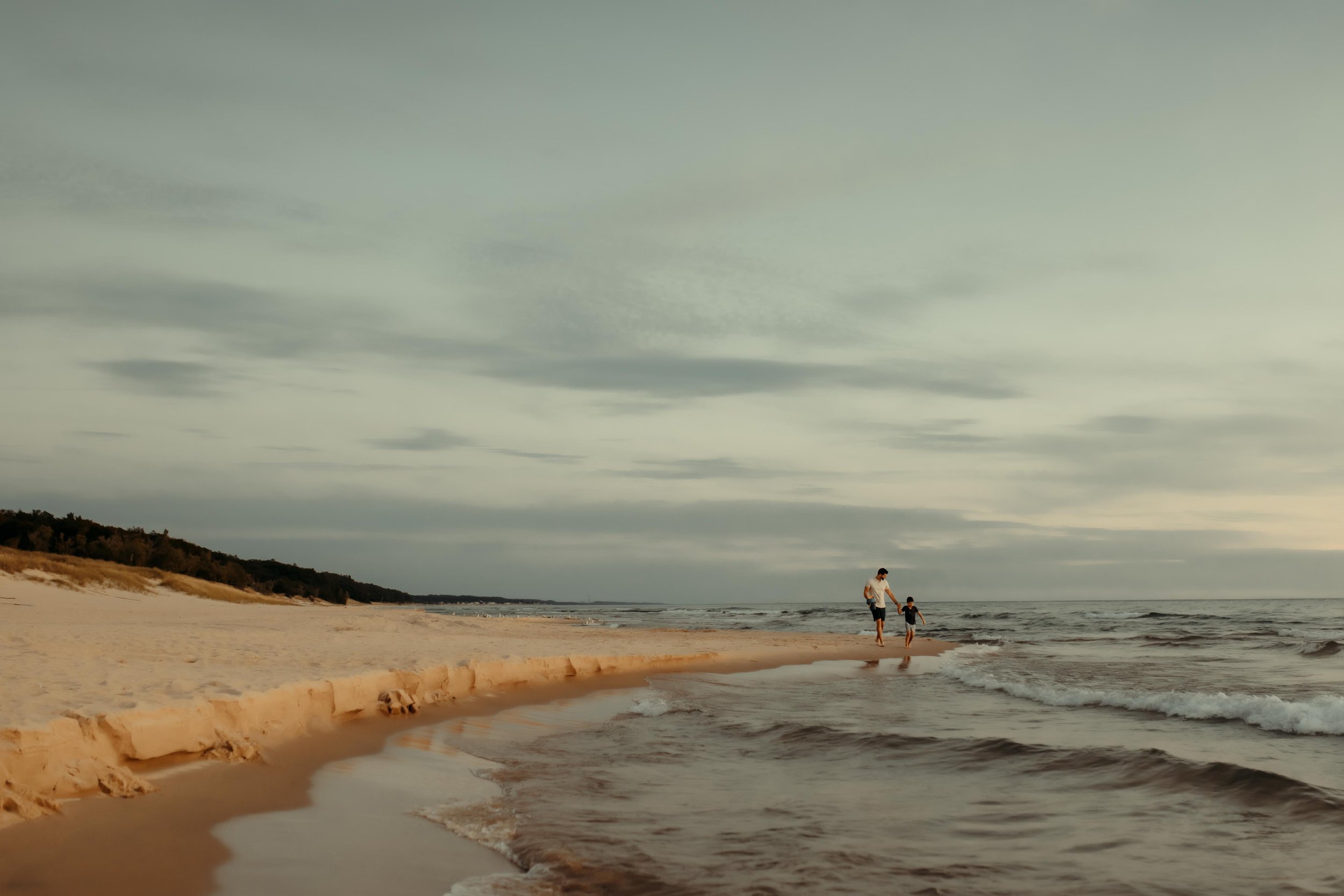 dad and son at the beach in grand haven, michigan