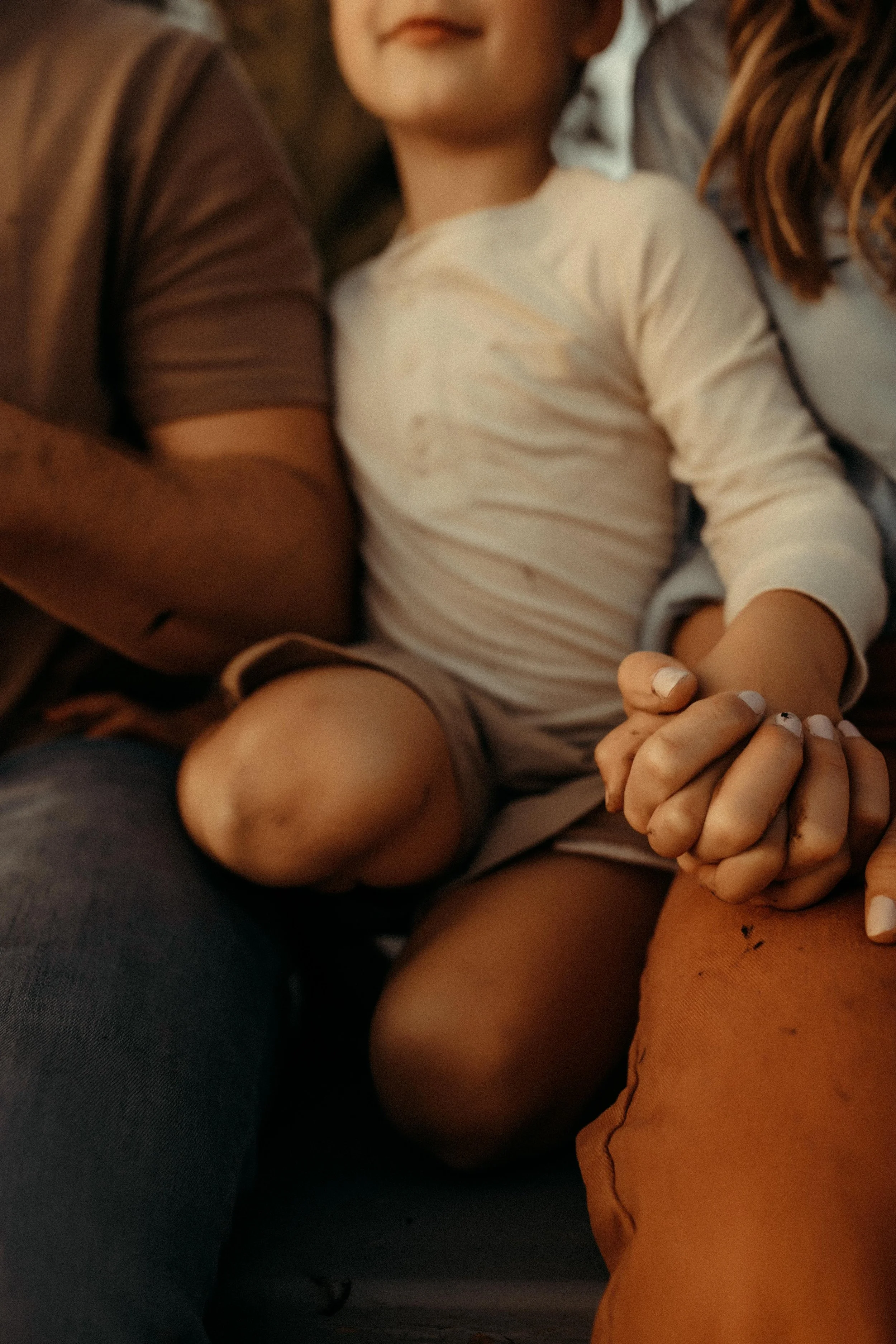mother and son holding hands while fishing during family photography session in west michigan