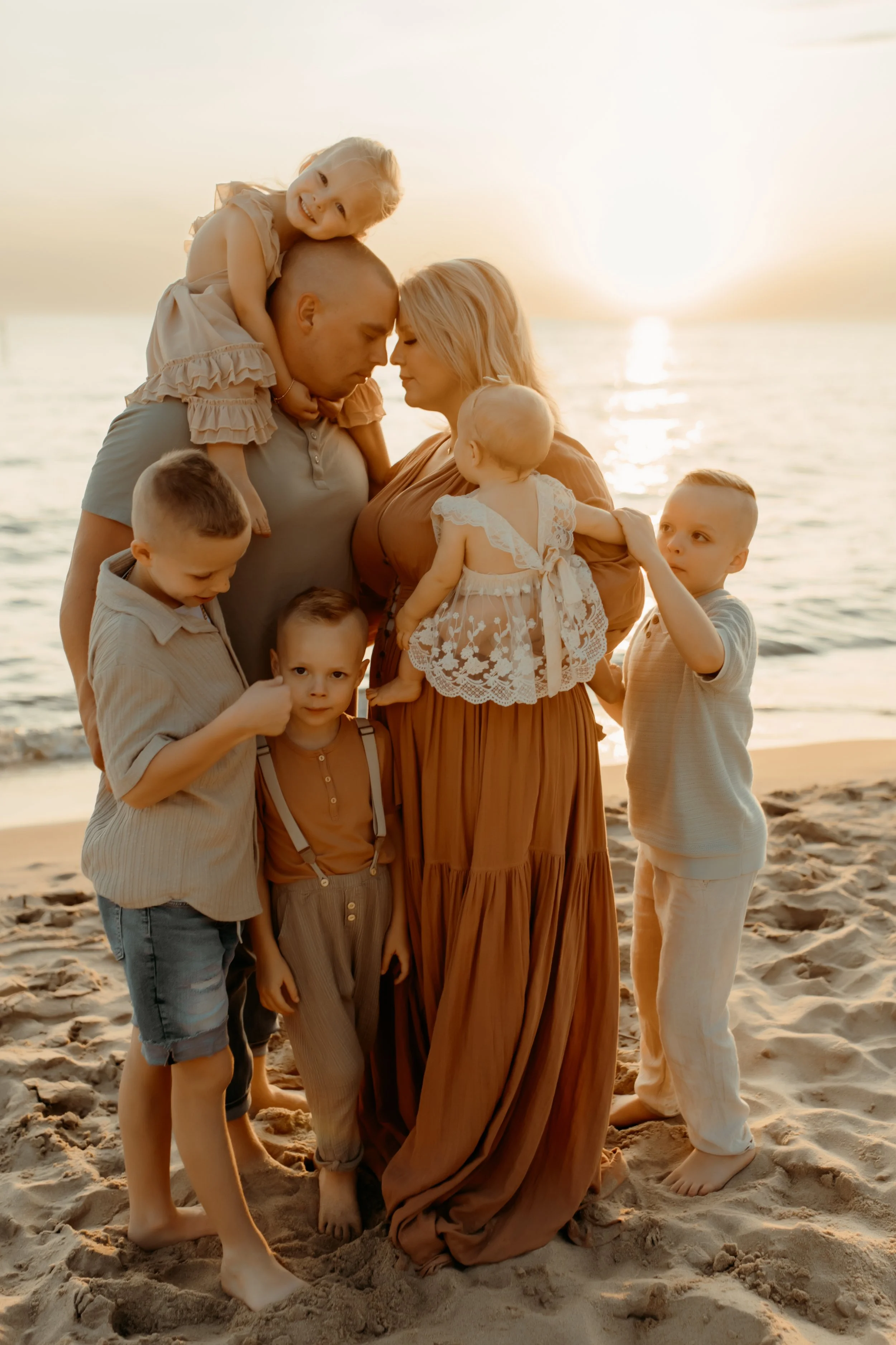 Family on the lakeshore of Lake Michigan beach during a Holland, Michigan family photography session