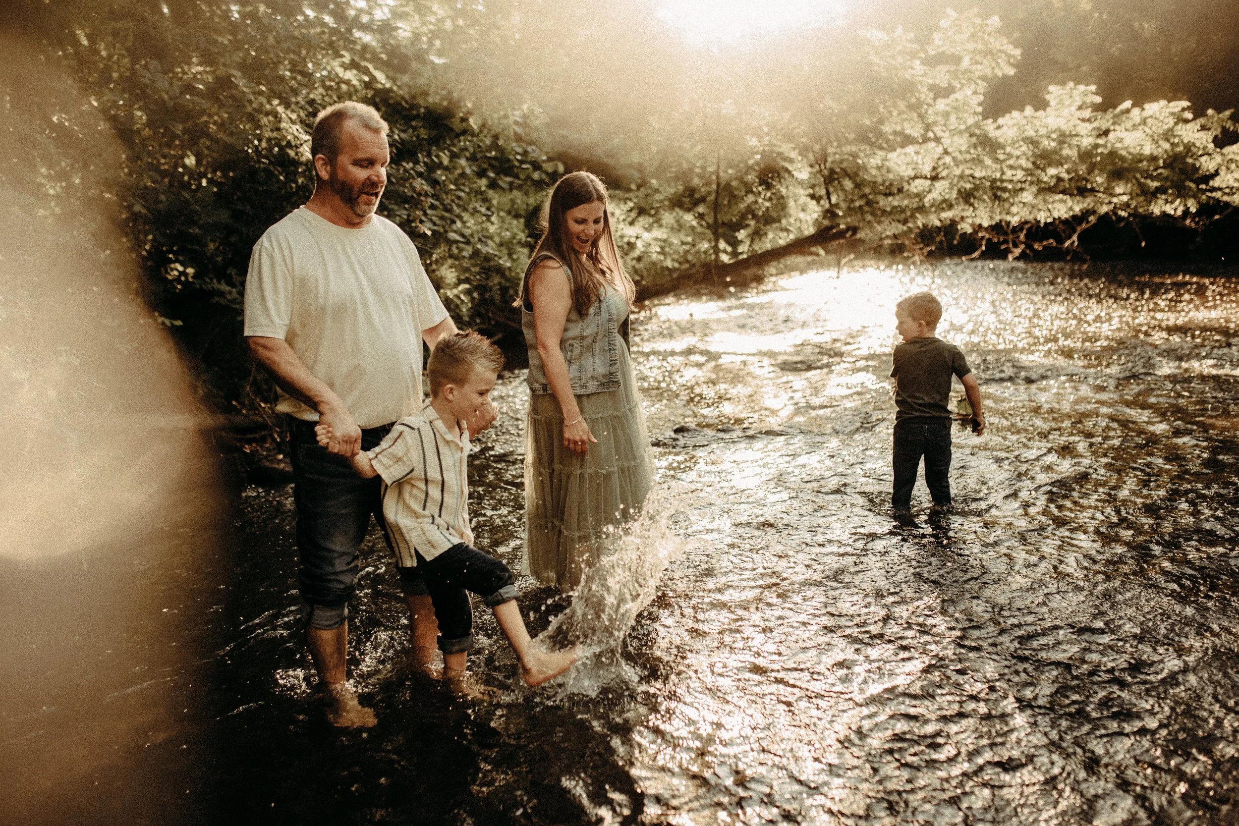 Family splashing in the creek during documentary photography session