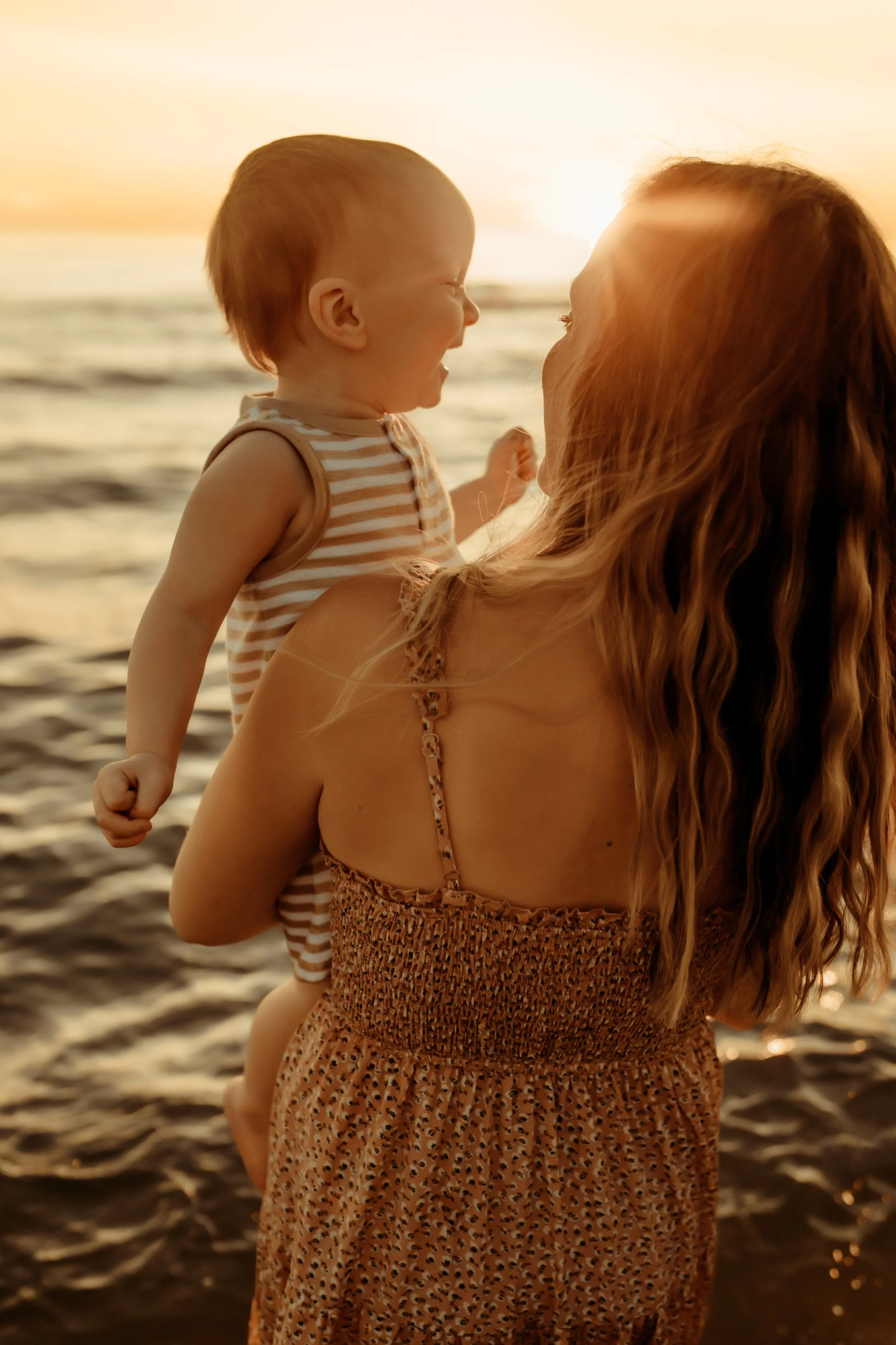 Child laughing at the beach in Holland, Michigan