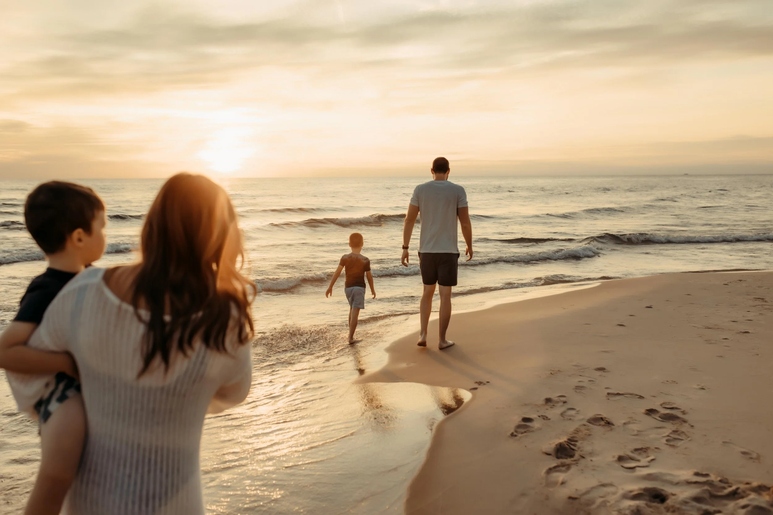 family walking along the lakeshore in grand haven, michigan