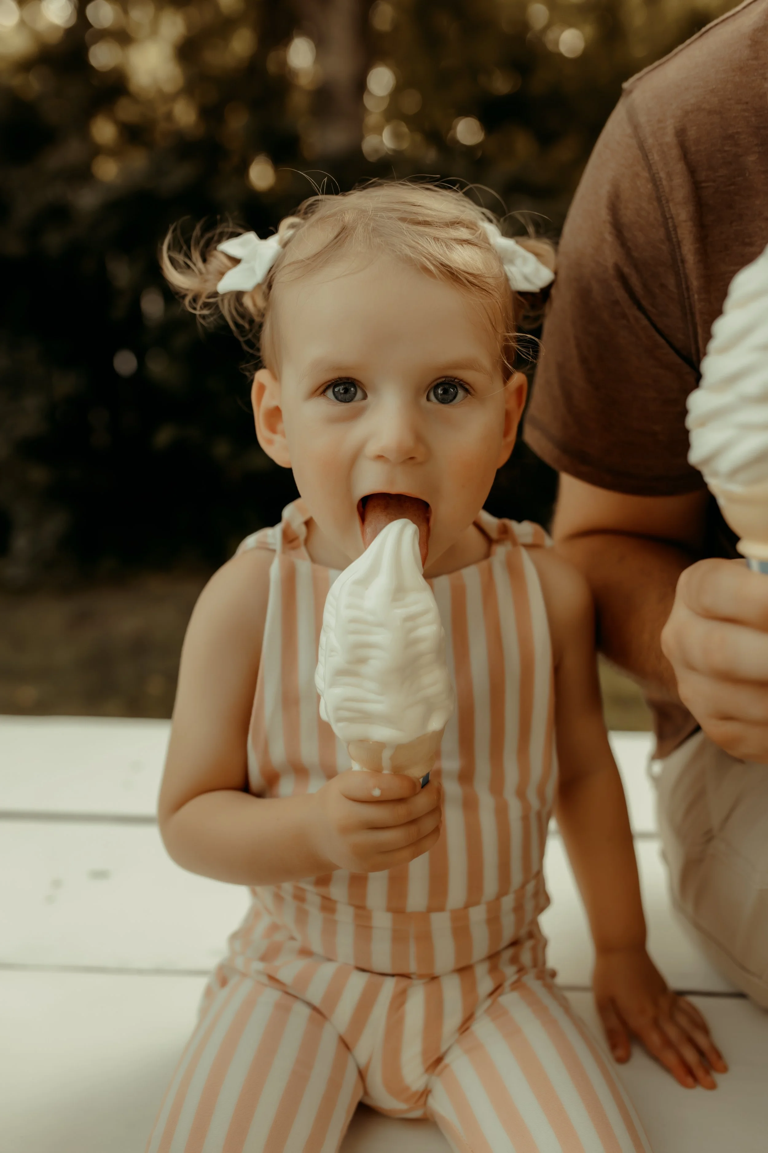Girl eating ice cream during lifestyle photoshoot in Holland, Michigan