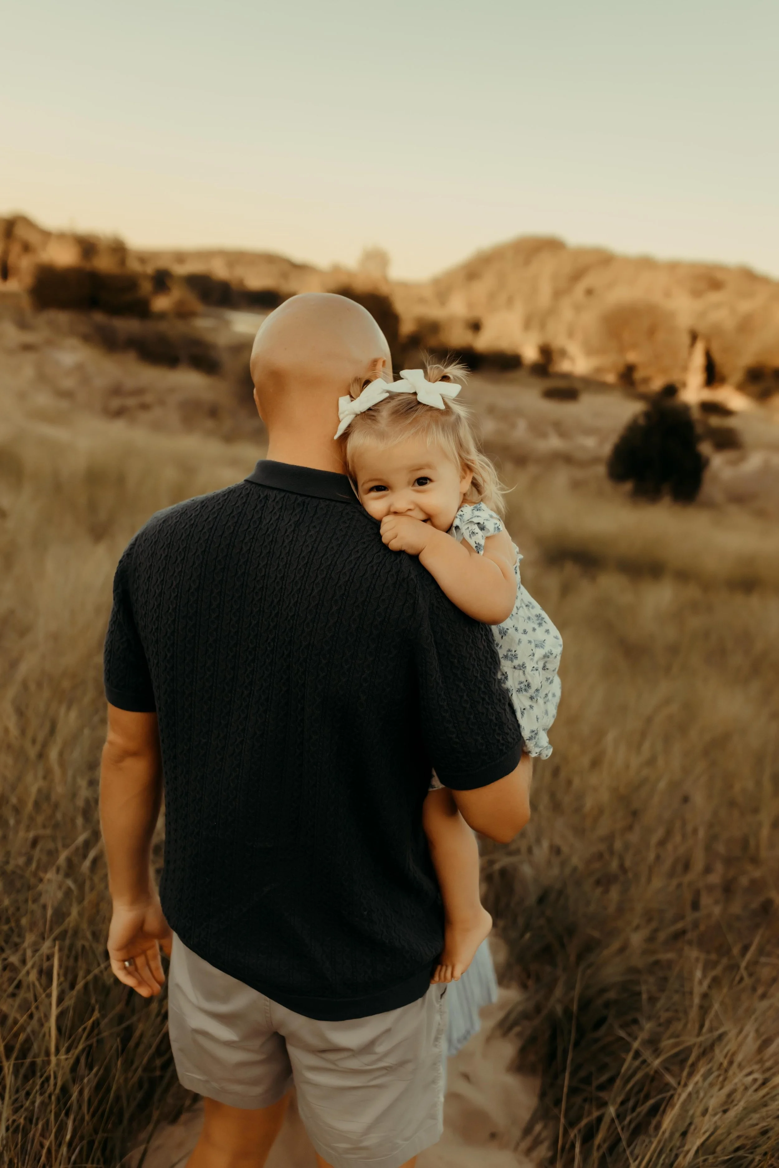 Father/daughter moment at the dunes at Oval Beach in Saugatuck, Michigan at a family photography session