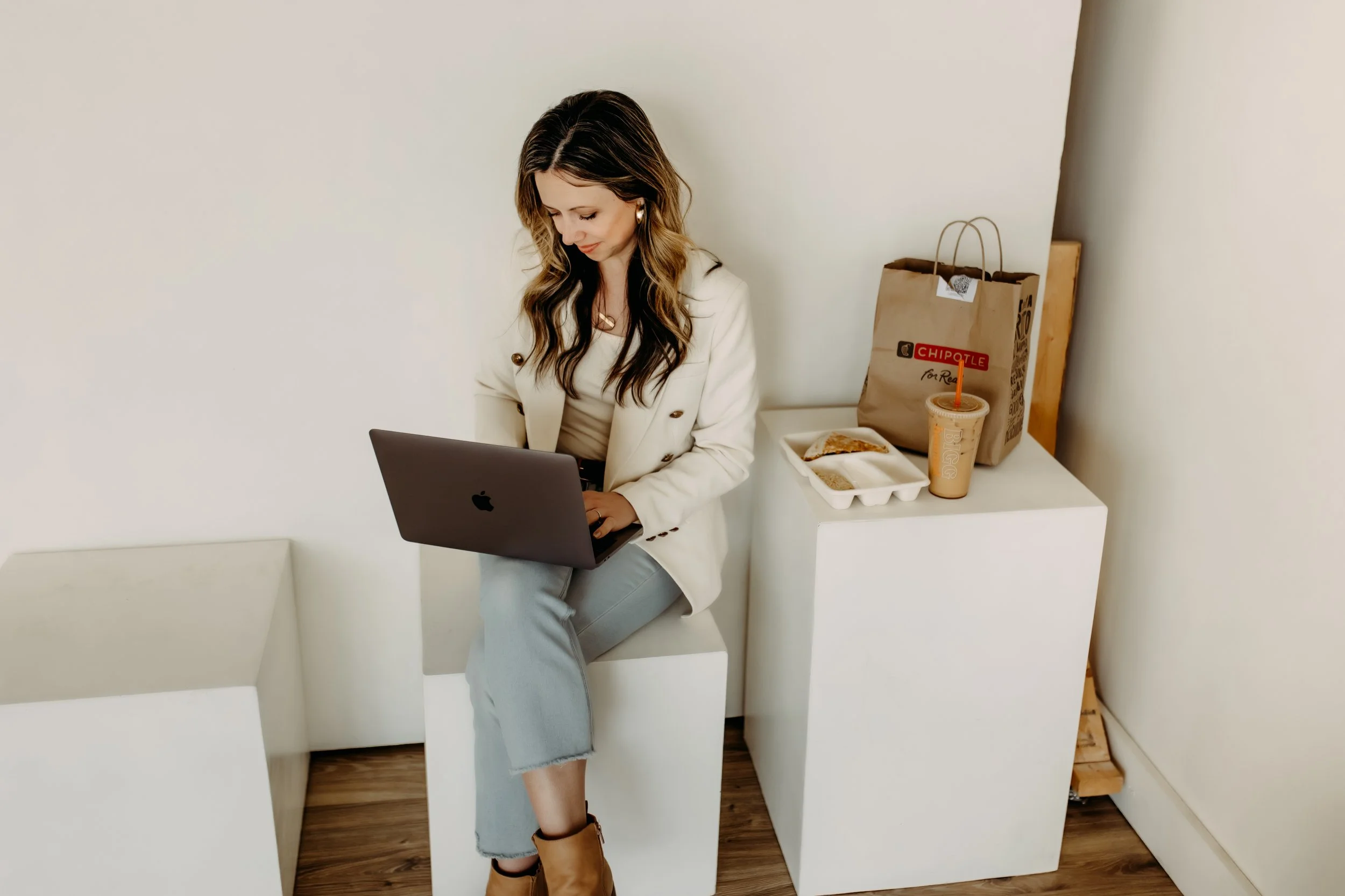 A Family photographer who loves coffee and chipotle working on her laptop