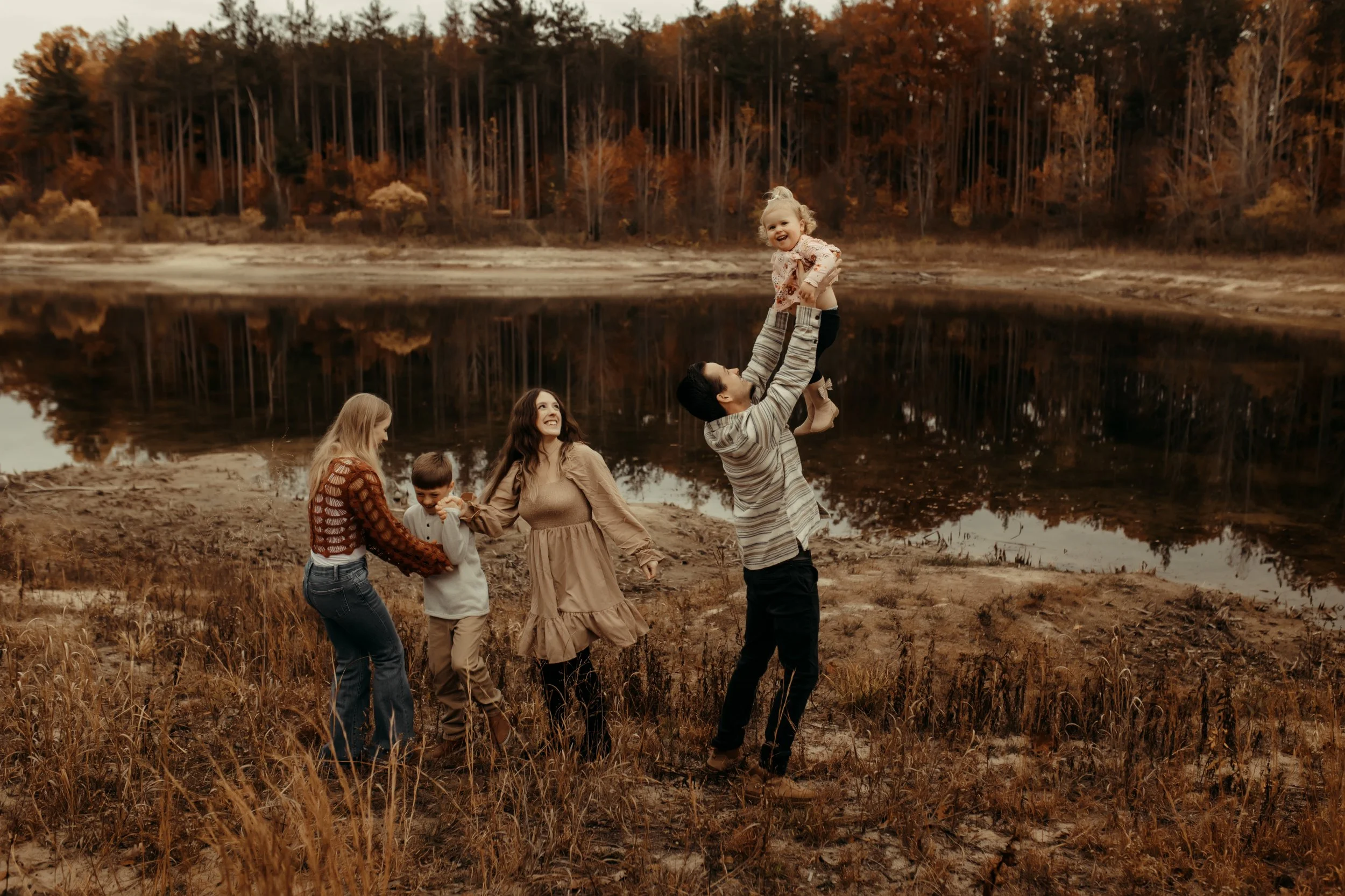 Family playing at photography session at Riley Trails in Holland, Michigan