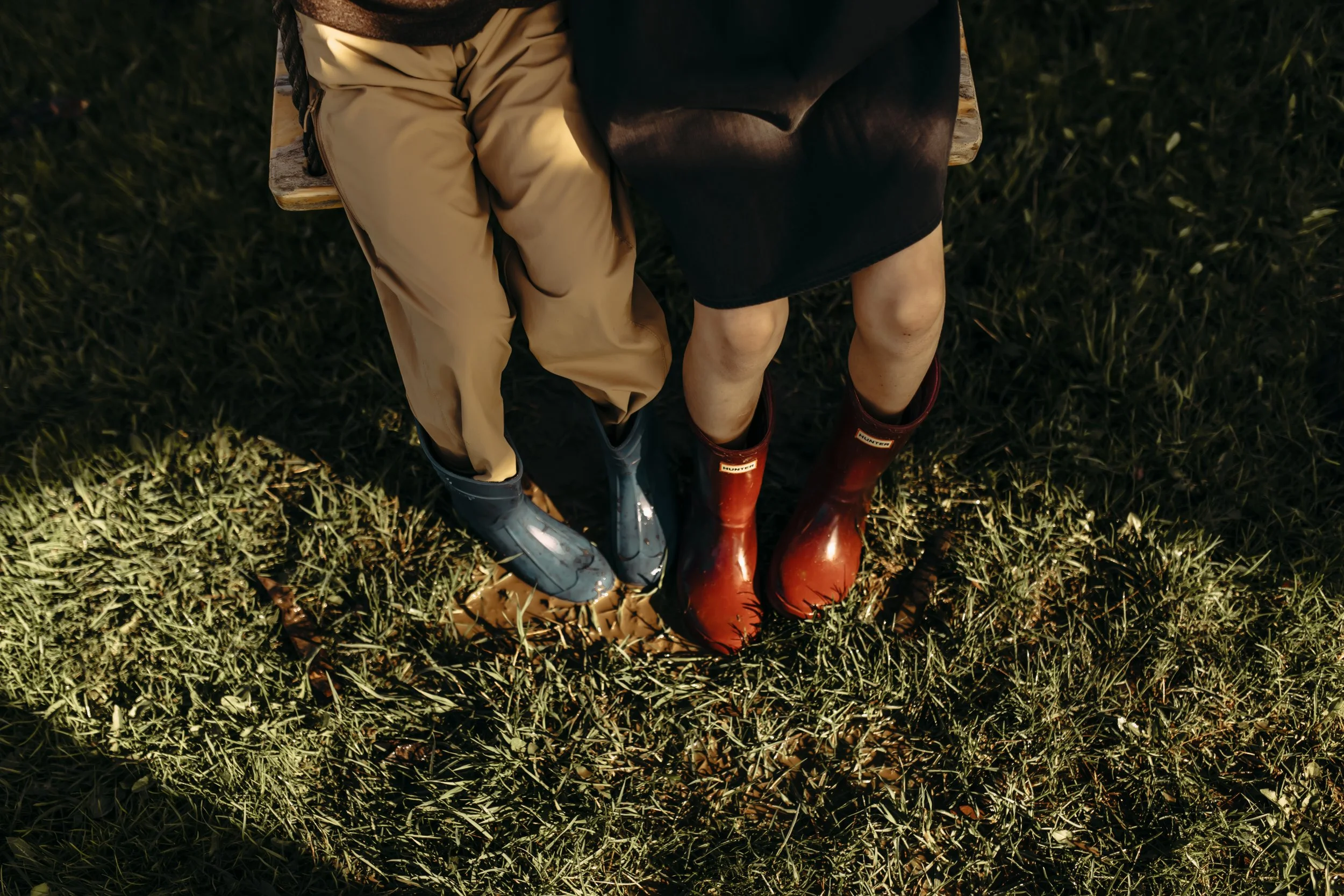 Family photography session in Hudsonville, Michigan with kids playing in puddles with their rainboots