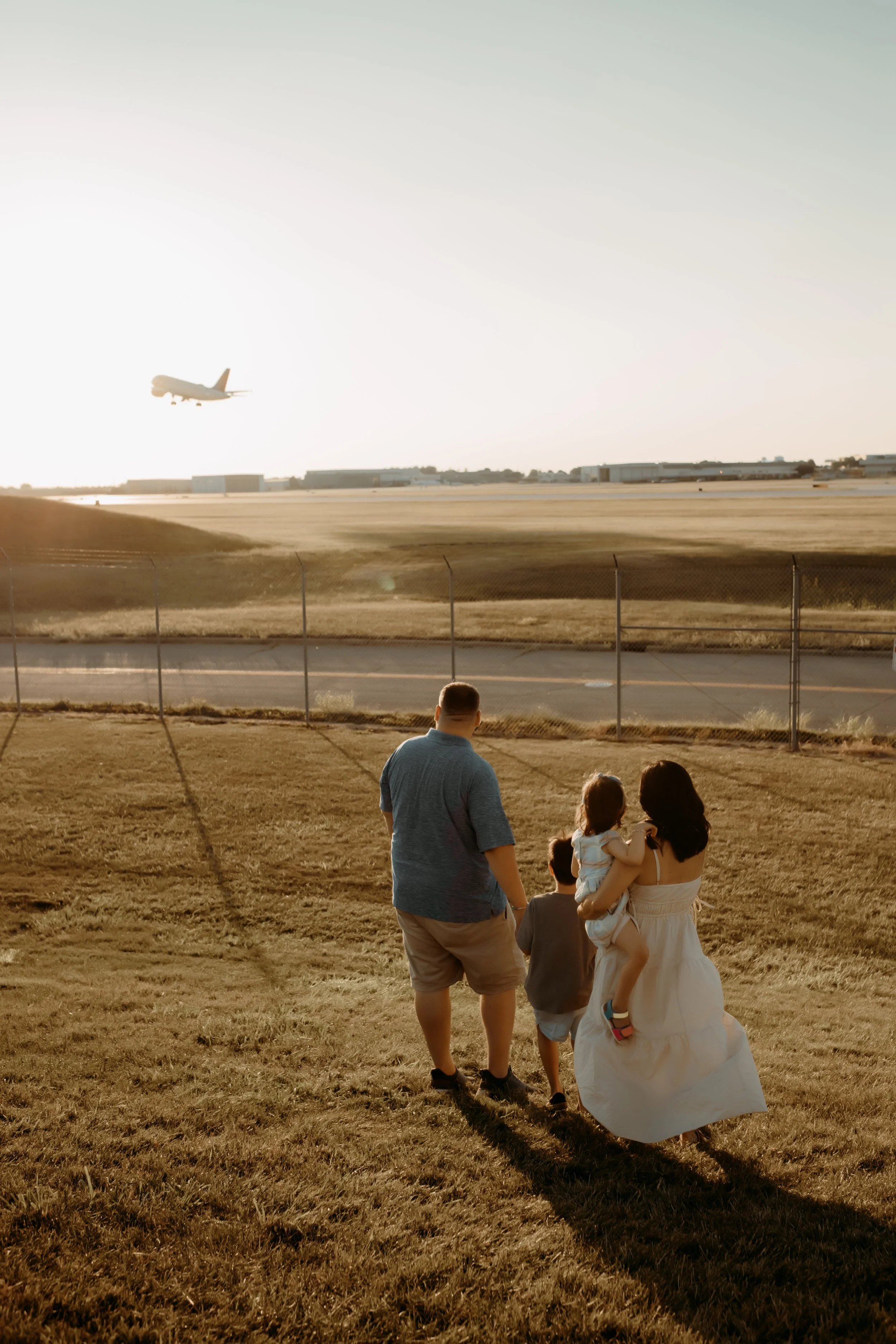 A family watching airplanes take off at the Grand Rapids Airport