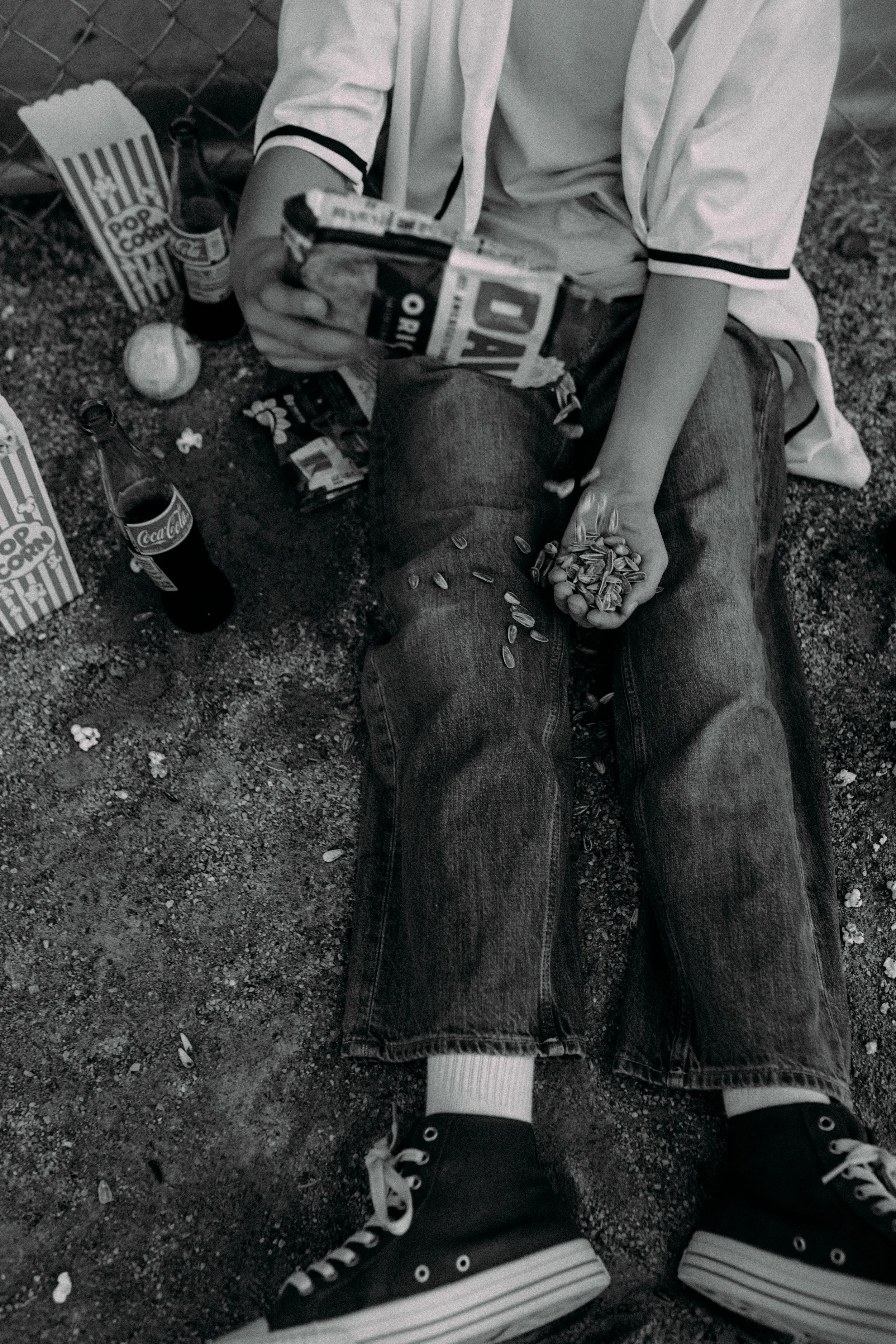family eating sunflower seeds and drinking coca cola during family photo session in grand rapids, michigan