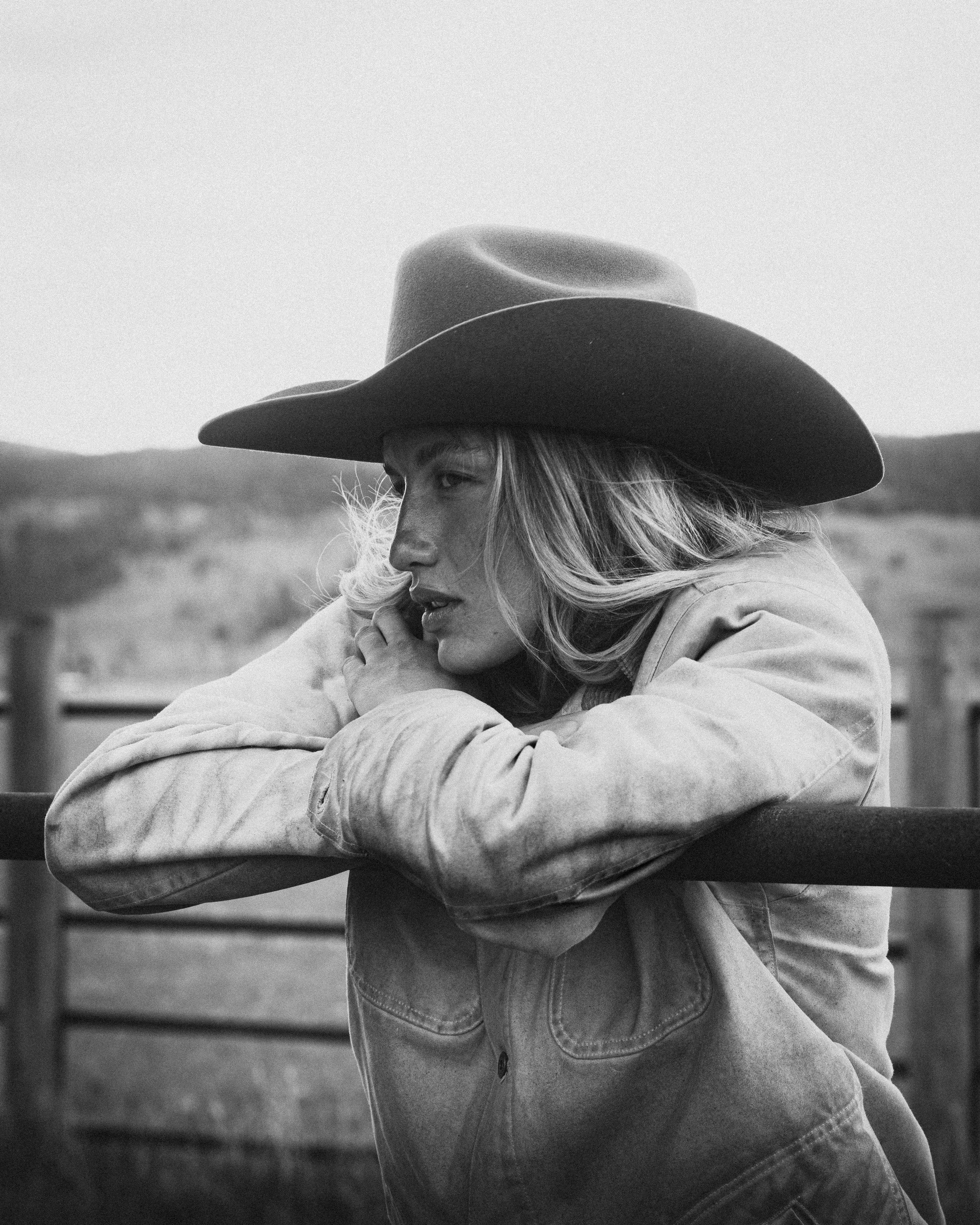 cowgirl on fence post