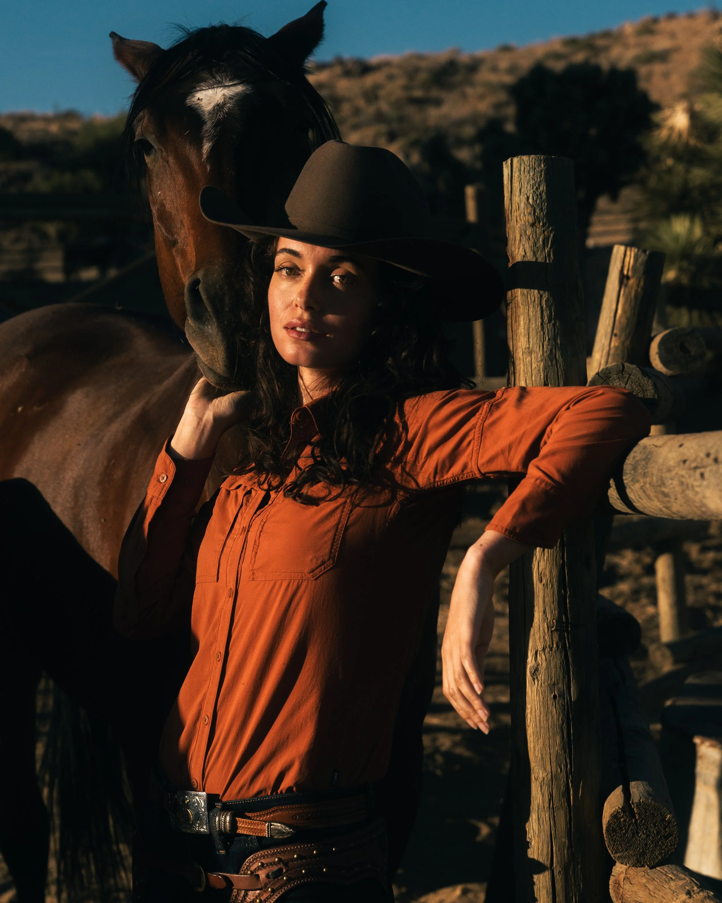 cowgirl holding horse head 