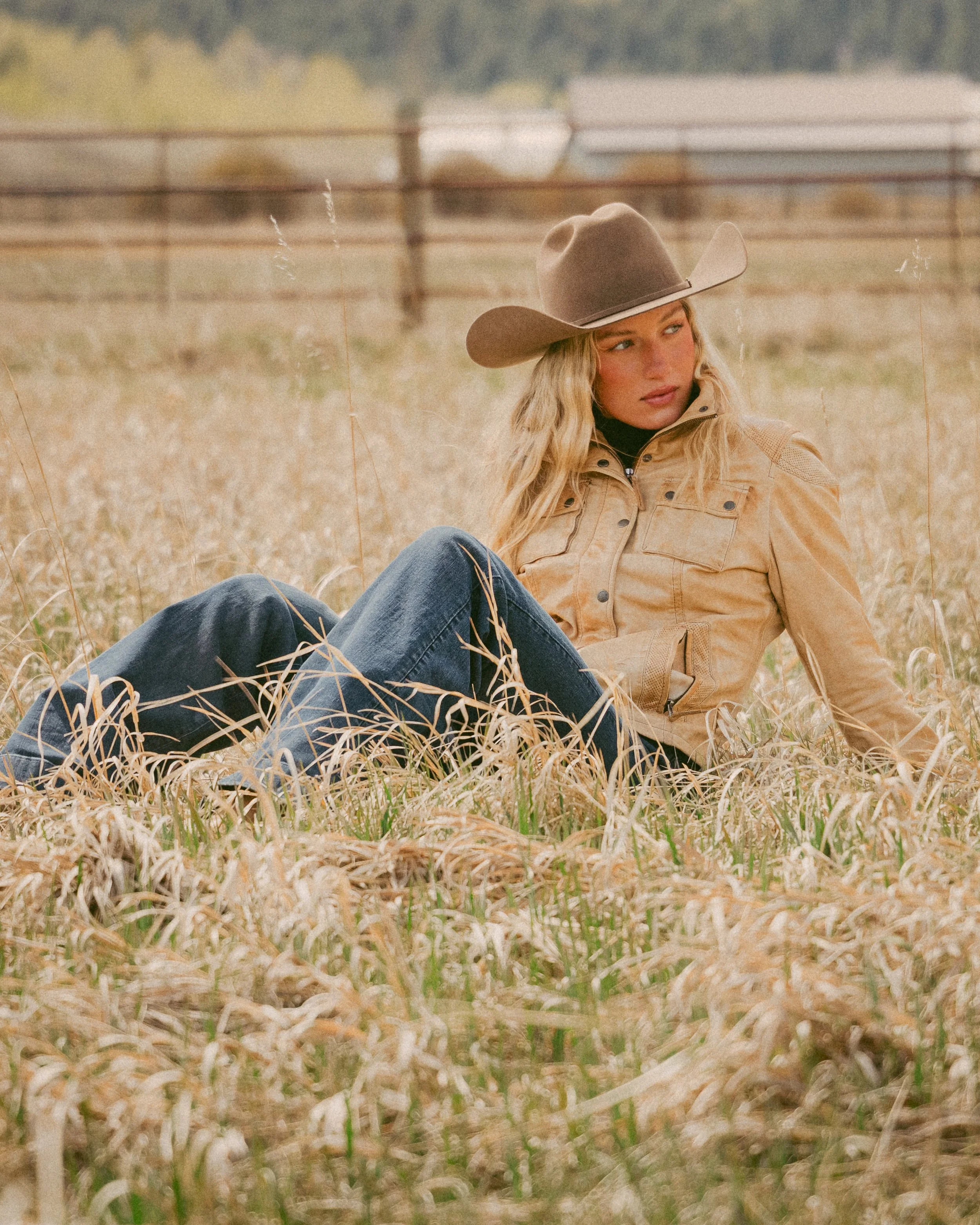 cowgirl sitting in an open field