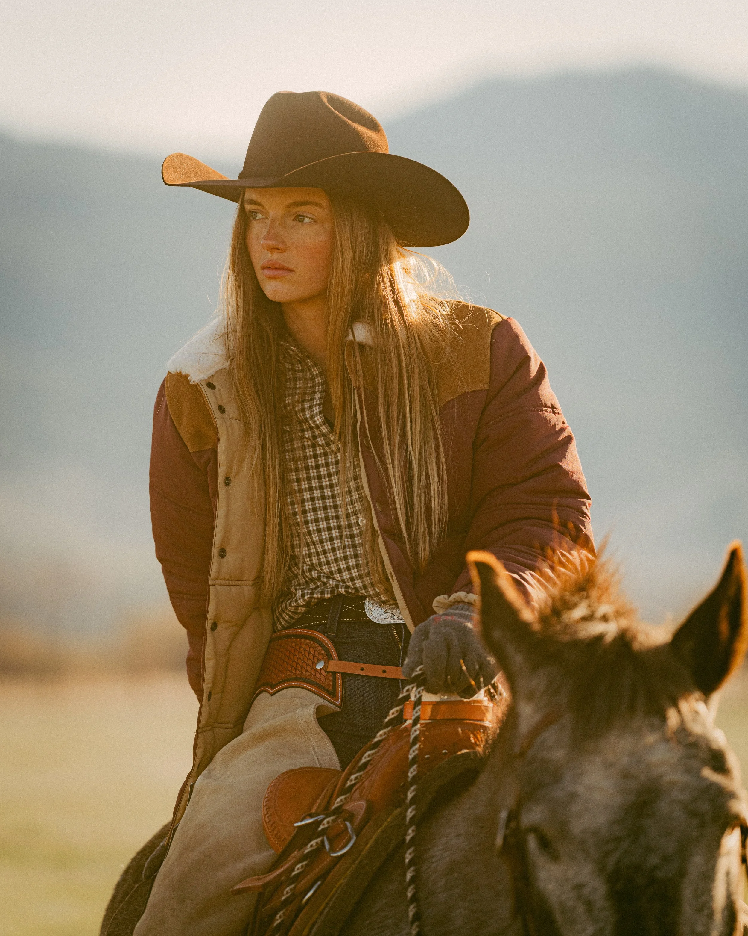 cowgirl on horse during sunrise