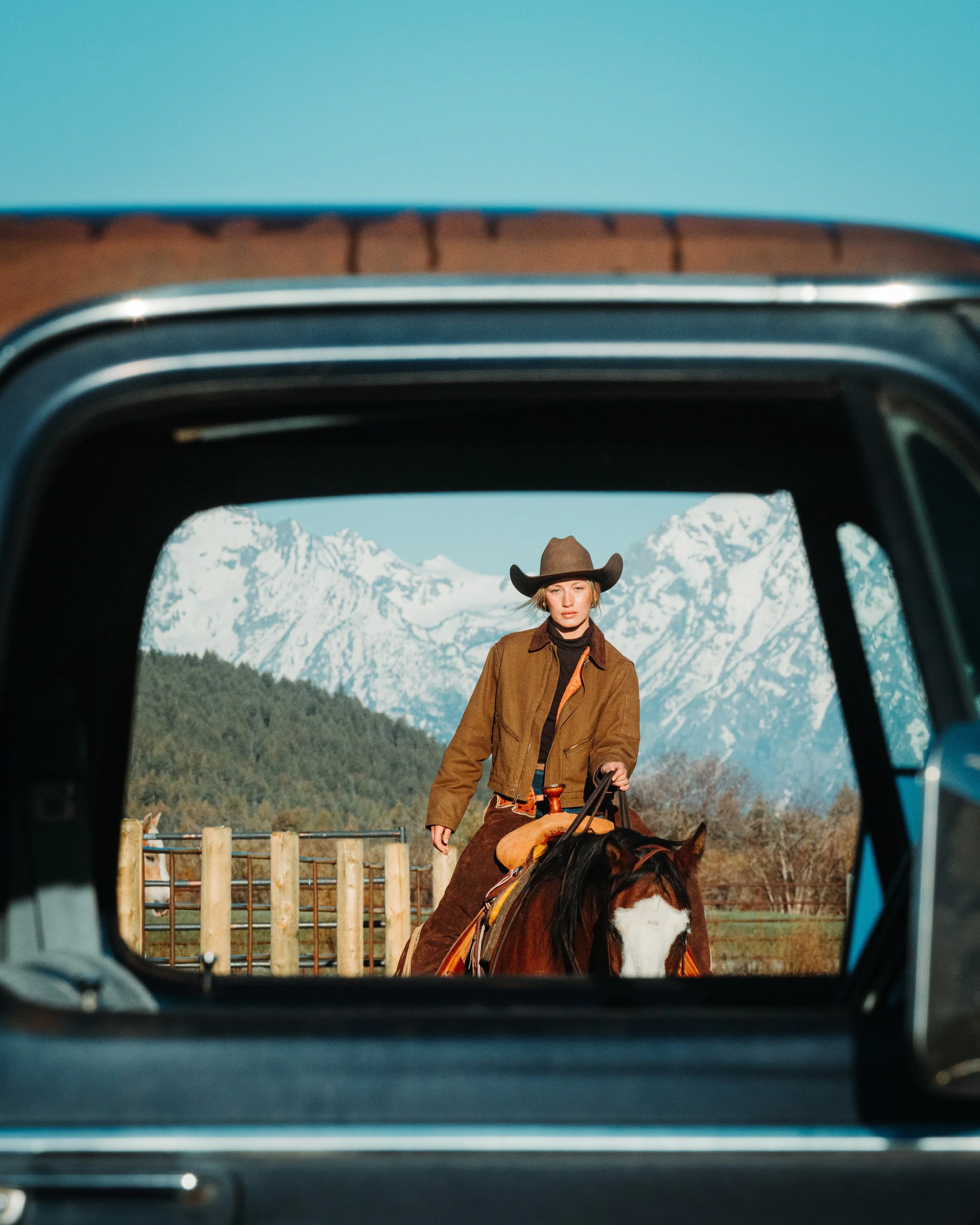 vintage truck and cowgirl riding horse