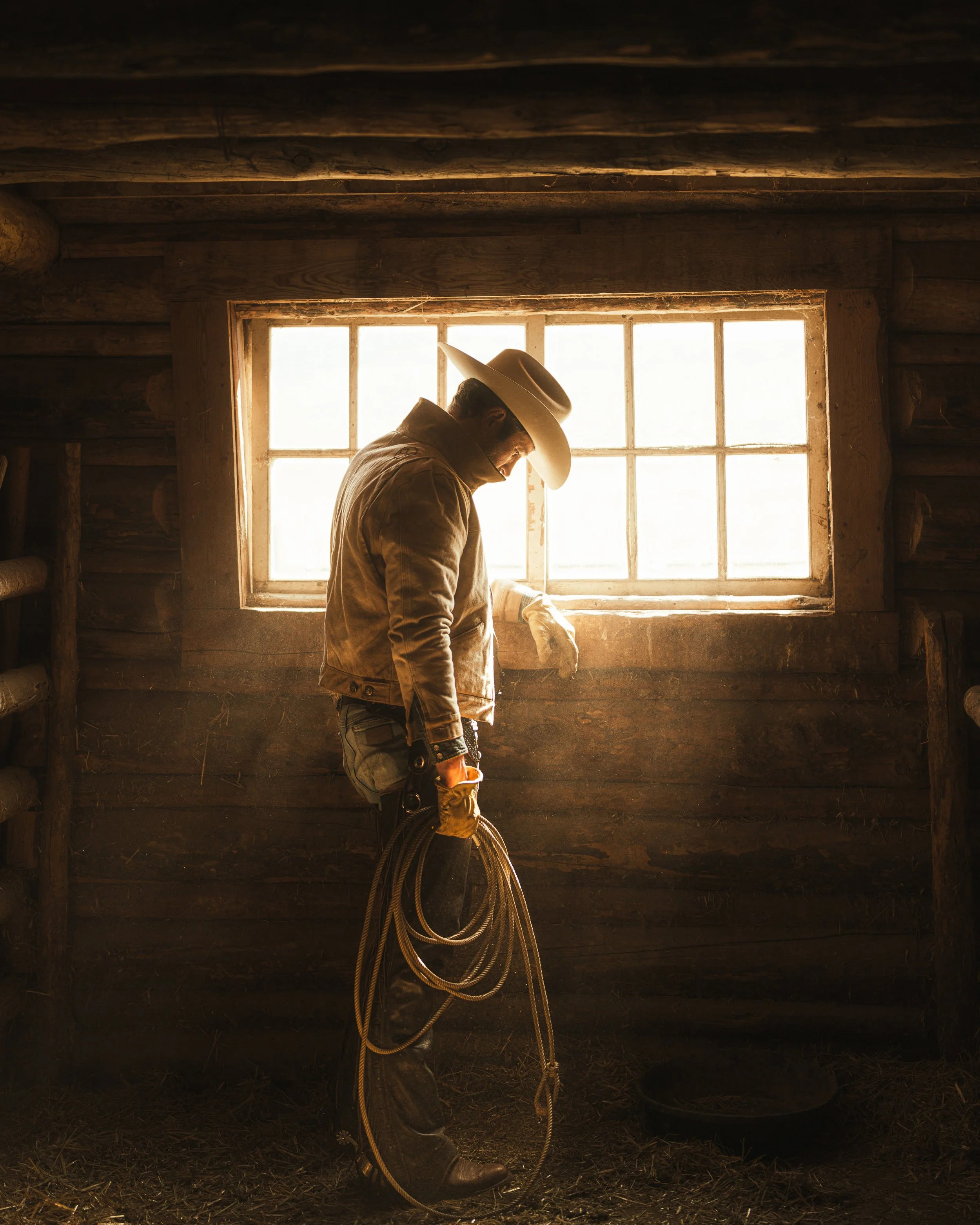 photo of cowboy in barn with golden light