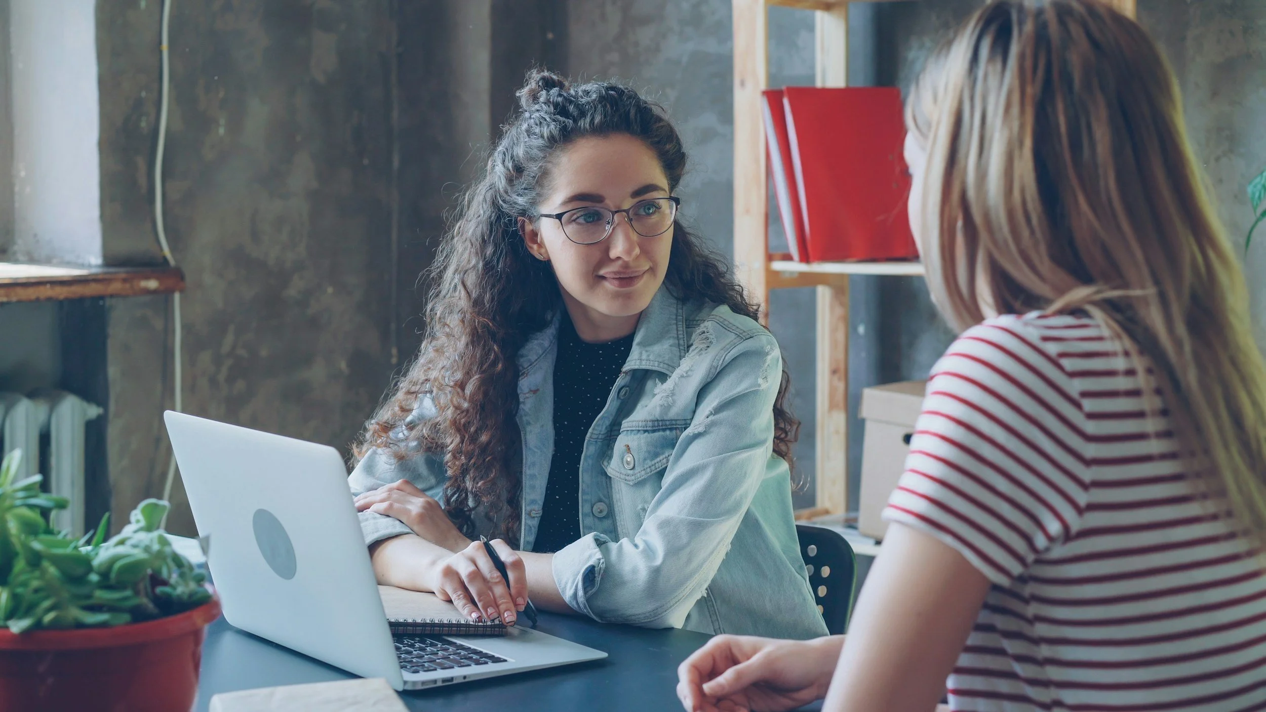 woman focused and engaged writing in notebook during structured therapy for OCD and anxiety