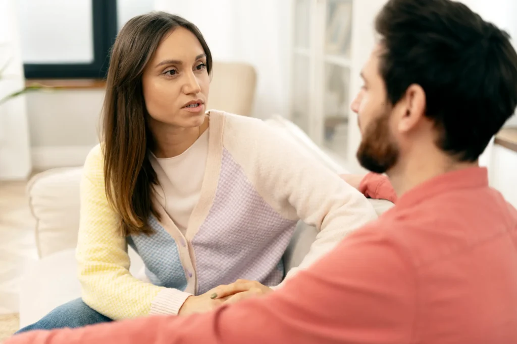 woman explaining something emotional to partner while partner listens but appears unsure how to respond